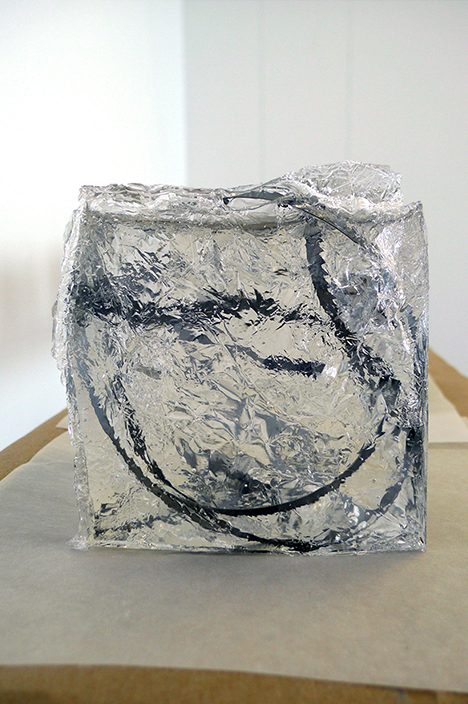 1/2 — BANDERSNATCH/THE TAMING OF THE SNARK.  The eight individual Bandersnatch sculptures are hand-cast in ballistics gel, a mostly translucent material representing the density of human flesh. The material is often used for weapons testing and the evaluation of wound penetration. Bandersnatch (One) from the installation The Hunting of the Snark, which is composed of eight sculptures. Each piece measures approximately 16 cm x 16 cm x 16 cm; the suspended shelf is approximately 30 cm x 3 cm x 214 cm and hangs 188 cm from the ceiling. Ballistics Gel with suspended stainless-steel band saw blades, oak panel, wire, tracing paper, kraft paper, soap, razor blade, 2013.