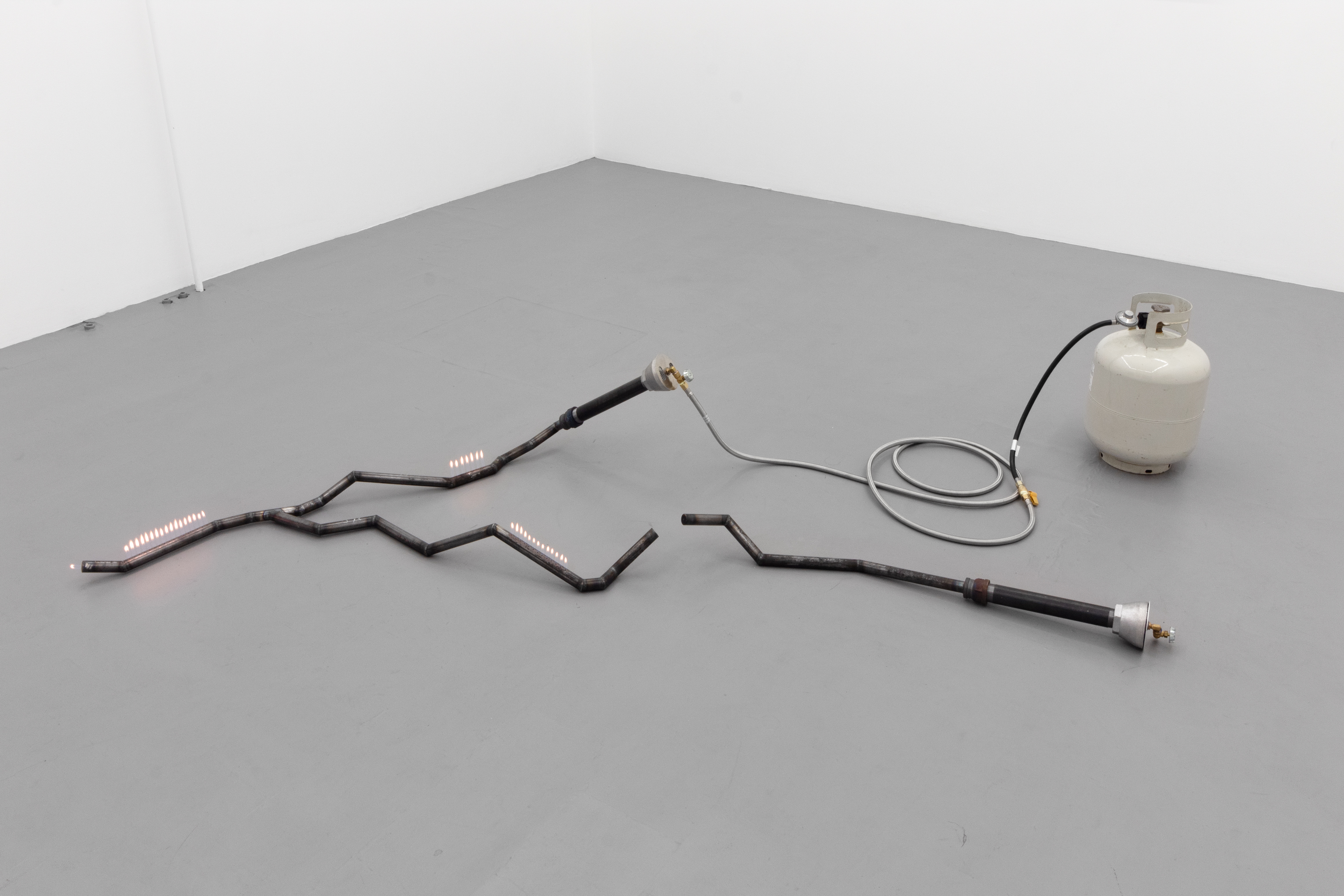 The world was created by fire, by dance (Mapa del sol muerto) - Steel tubes, propane tank, matches, gas tubing, sealant, fire. Dimensions variable. 2024