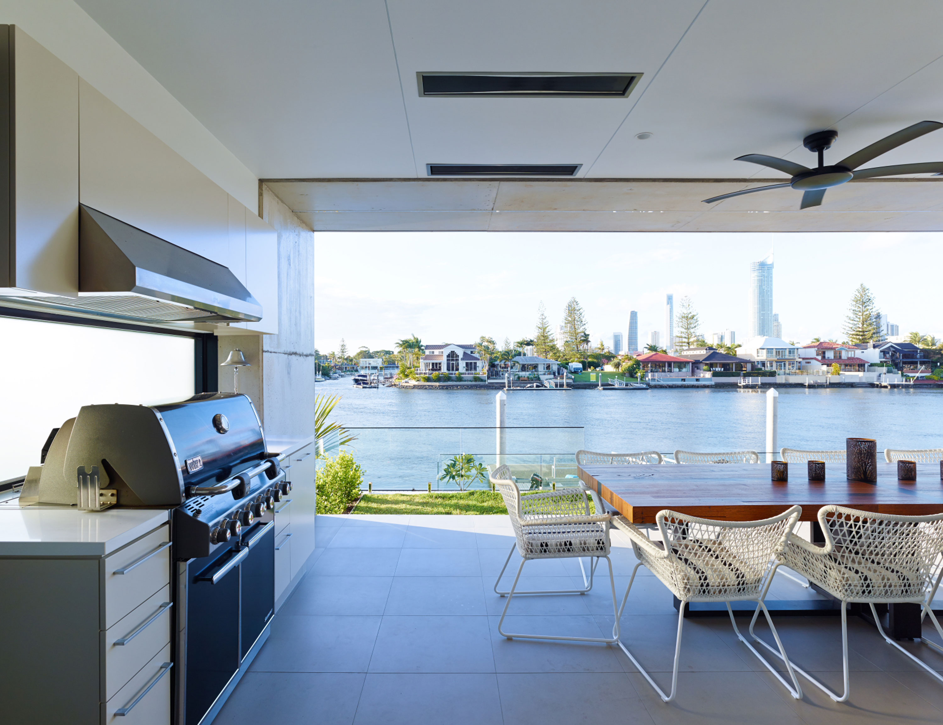 Outdoor entertaining and barbeque overlooking the river, with views to the city beyond.