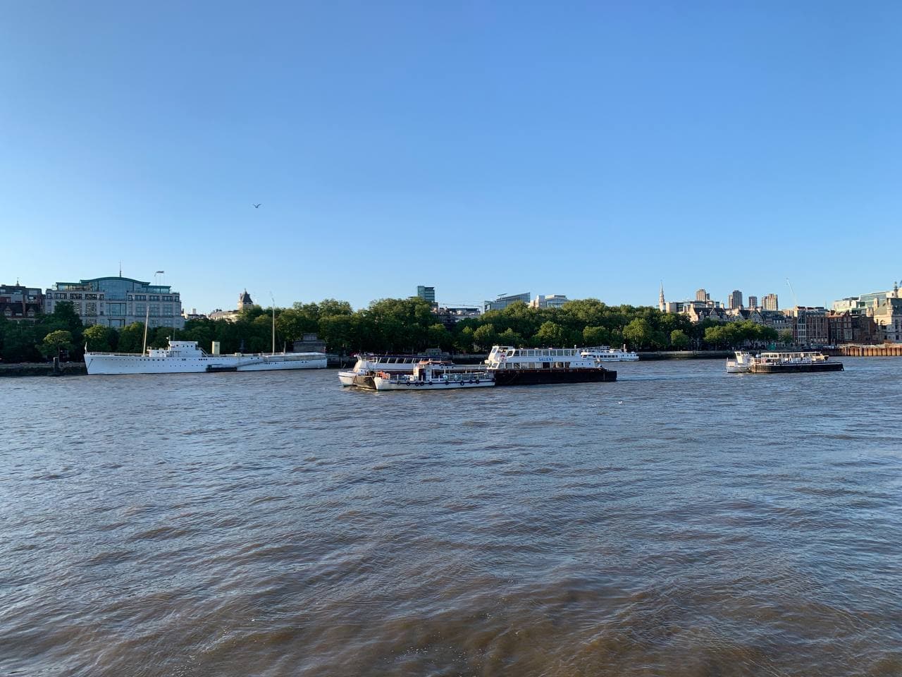 Multiple boats floating on the River Thames