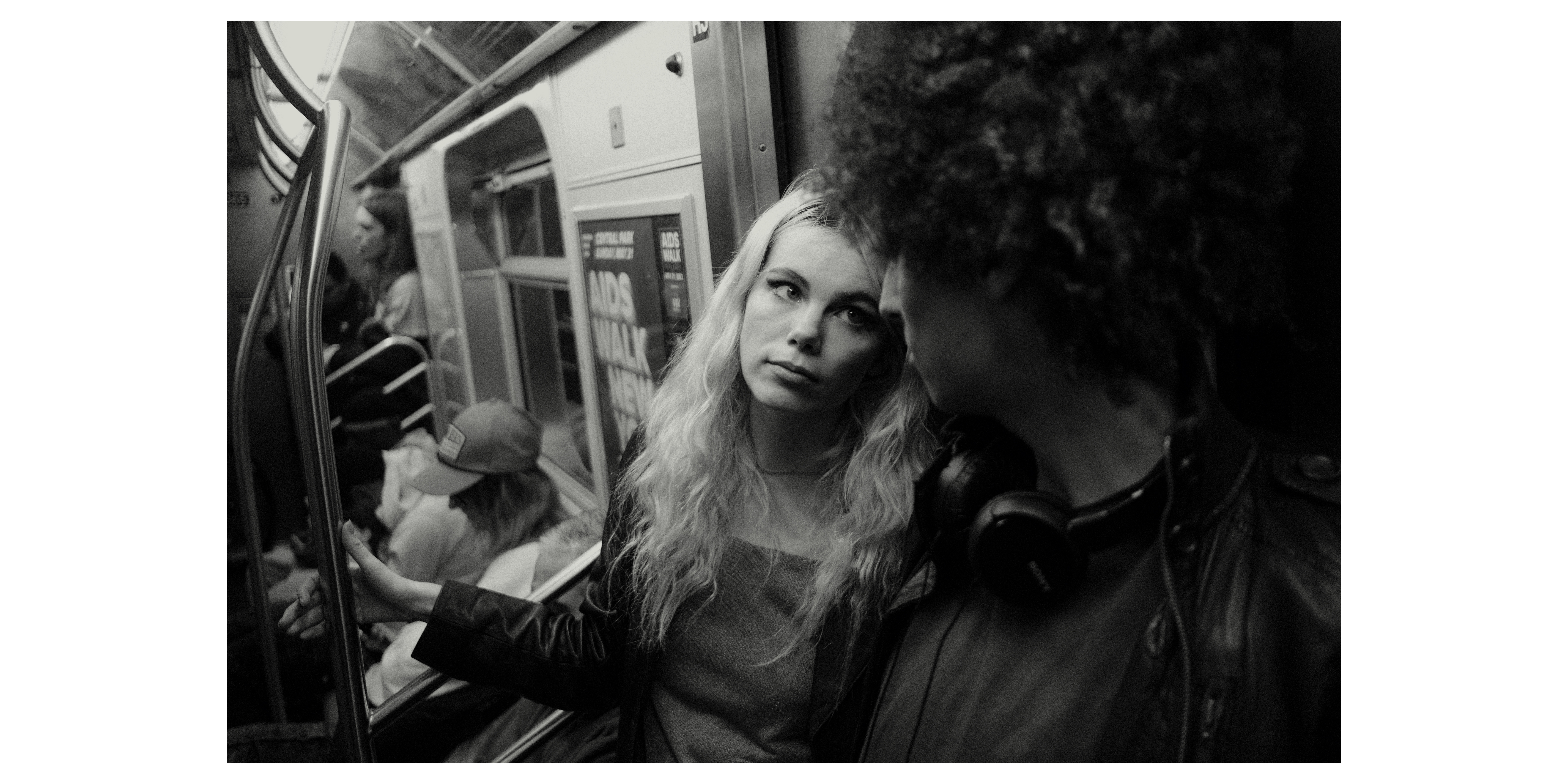 Maraya looks up at Avi on the train