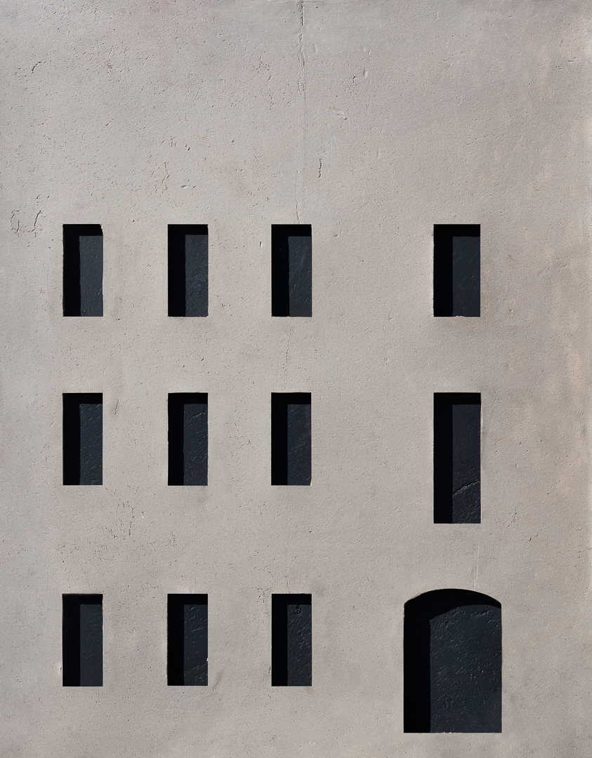 plane gray building façade made out of clay with black windows and doors 