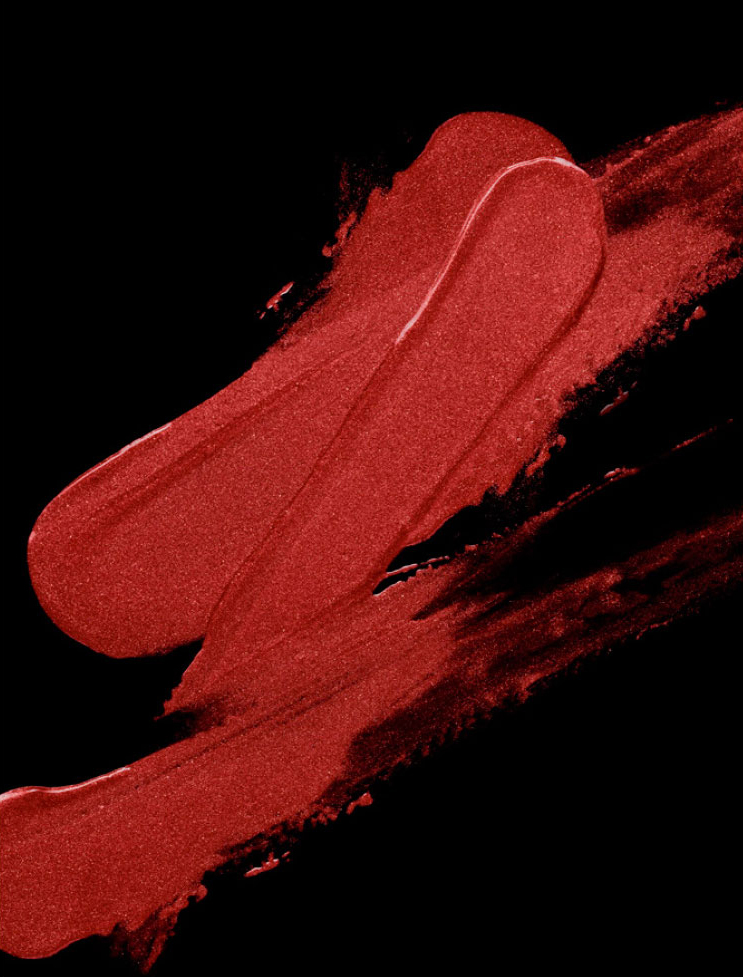 KMA stylist Rachel Haas designs set for texture photo of smeared creamy red lipstick on black background for Gucci