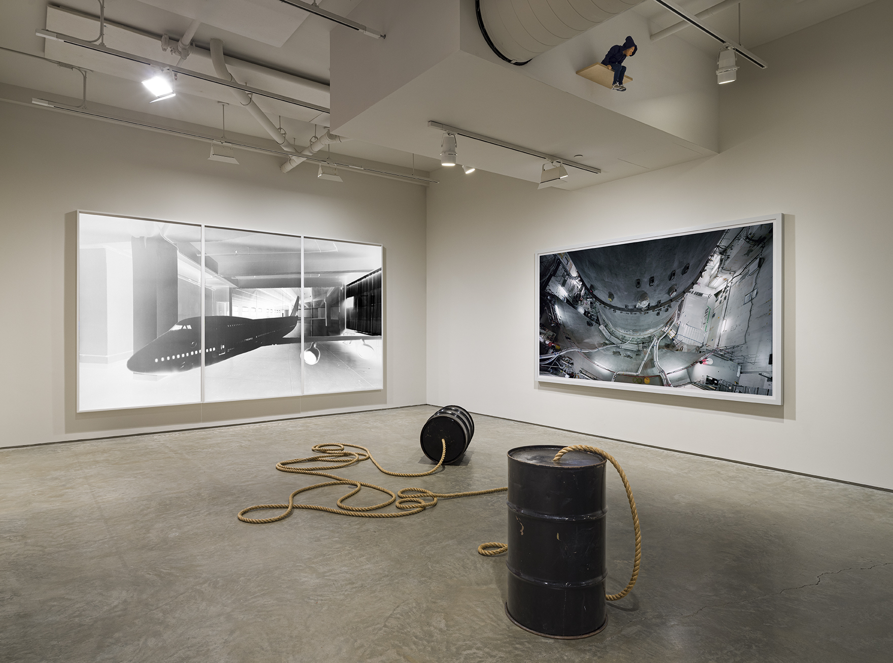 Left: Vera Lutter, Studio, XXX: June 29 - July 18, 2006, 2006. Unique silver gelatin print, 91 1/2 x 168 inches. Right: Thomas Struth, Reactor Pressure Vessel Phase Out, AKW Würgassen, Beverungen, Germany, 2009. C-print, 69 1/4 x 122 1/4 inches. Center: Christian Marclay, Dialogue of the Giants, 1998. Metal drums and rope, each Drum: 28 3/4 x 18 1/2 inches.Photo by Etienne Frossard.