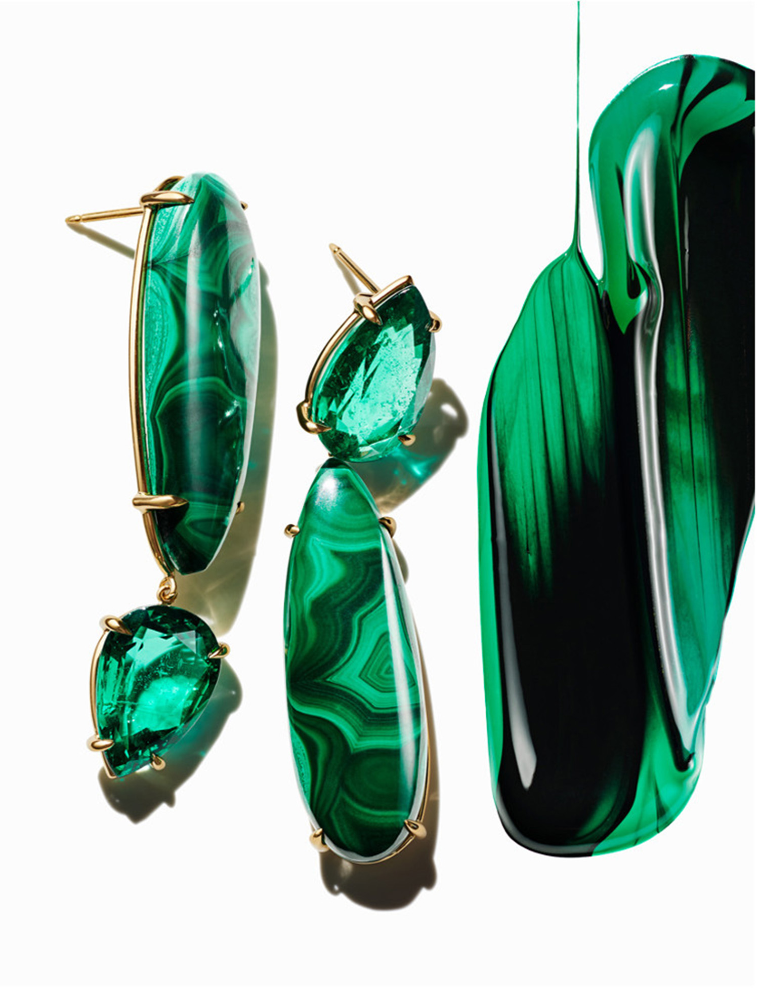 KMA stylist Sara Wacksman designs set for abstract photo of emerald earrings and green paint dripping on white background