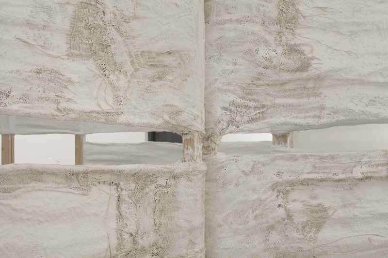 Untitled, 2014, variable size, plaster, burlap, plastic sheets, bricks, plastic emergency water storage bag, water