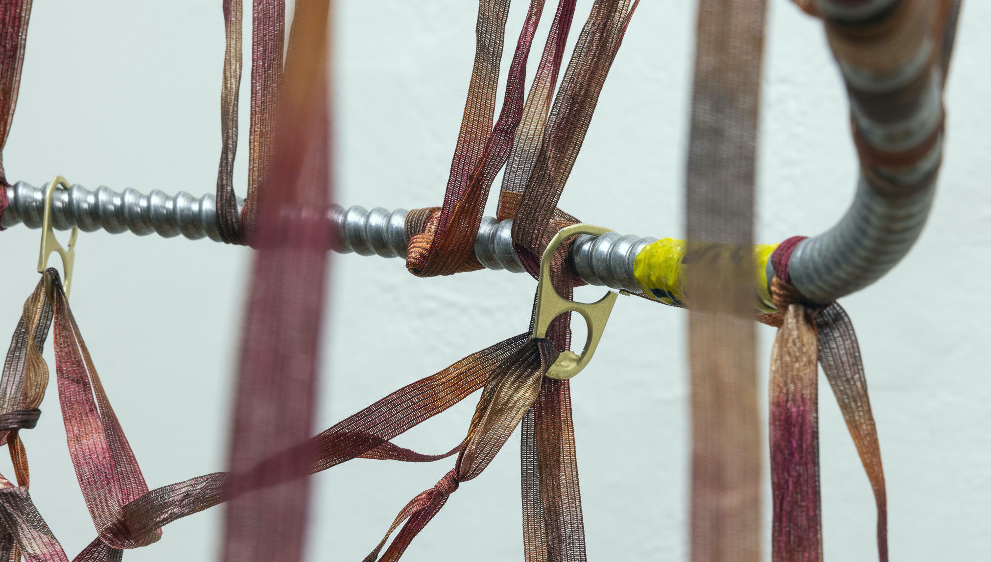 Detritus Dance | Found conduit wire, tape ribbon yarn, soda can tabs | 62 &frac14; x 15 x 15 in | 2024