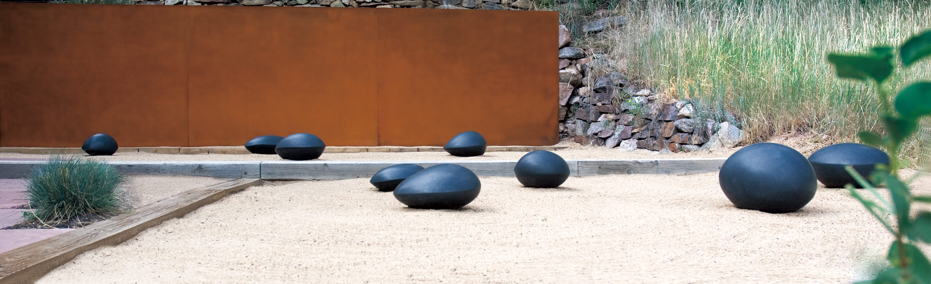 Group of Swedish Black Granite Resting Stones in sand garden. 2014