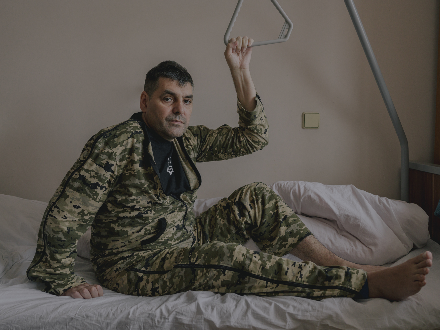 Petro Potehin, a colonel in the Ukrainian Armed Forces, poses for a portrait the day before his leg surgery. He was seriously injured during the mission to capture a village in eastern Ukraine, and to this day he hopes he will be able to keep both legs. Kyiv City, 20.11.2022.