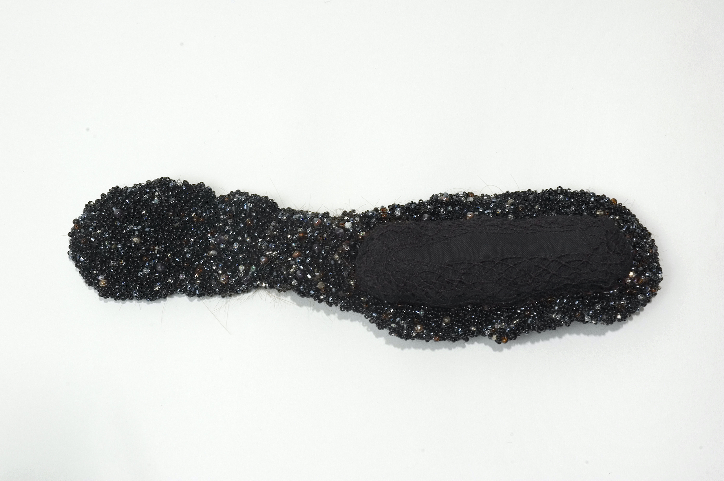  Negros, 2004 . Hand made felt, hair, cotton, silk and linen embroidered with beads . 27 cm . 