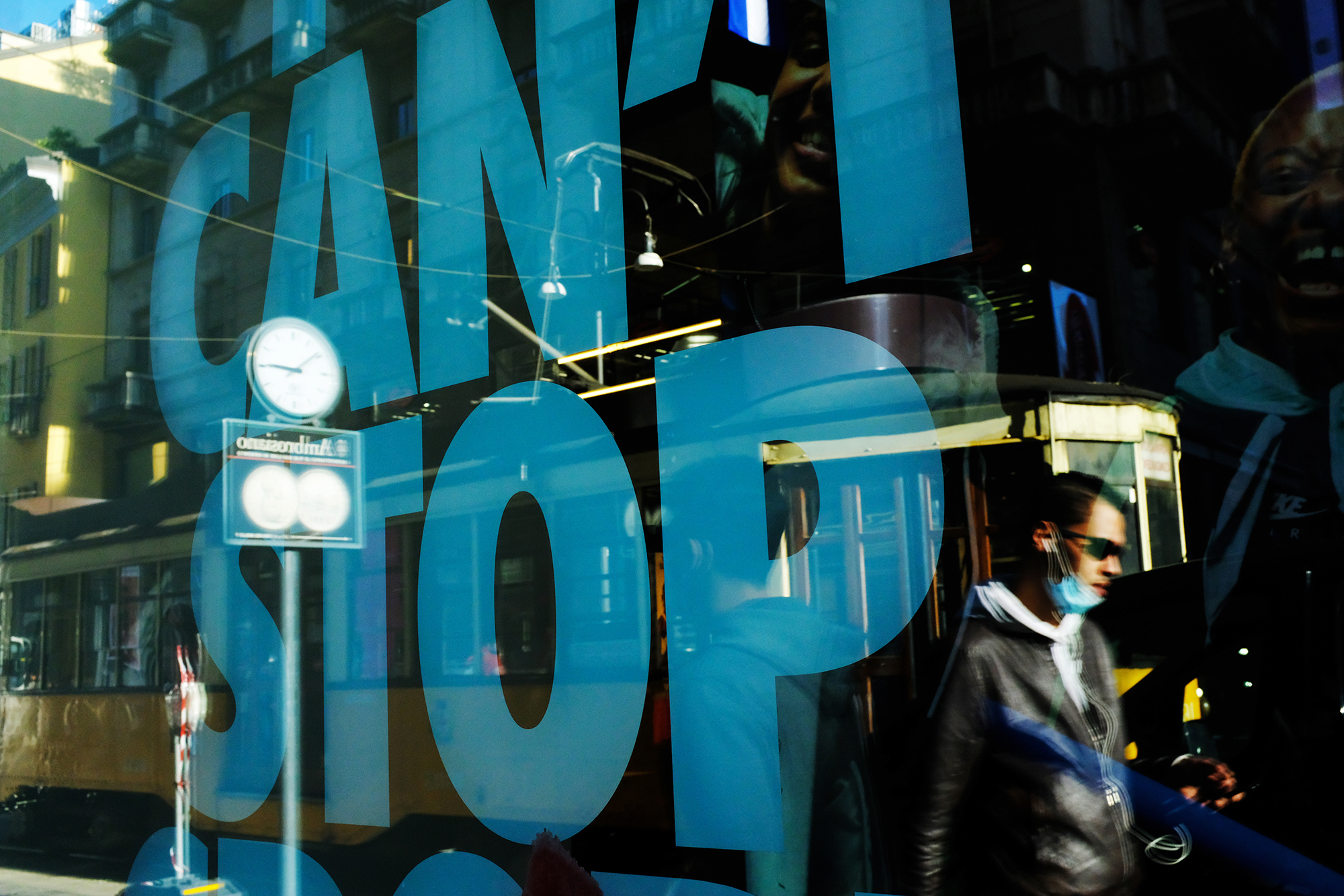 Philippe-Sarfati-reportage-photography-photographer-street-documentary-photojournalism-photojournalist-covid-19-pandemic-milan-italy-cant-stop-tramway-reflection-clock-man-walking