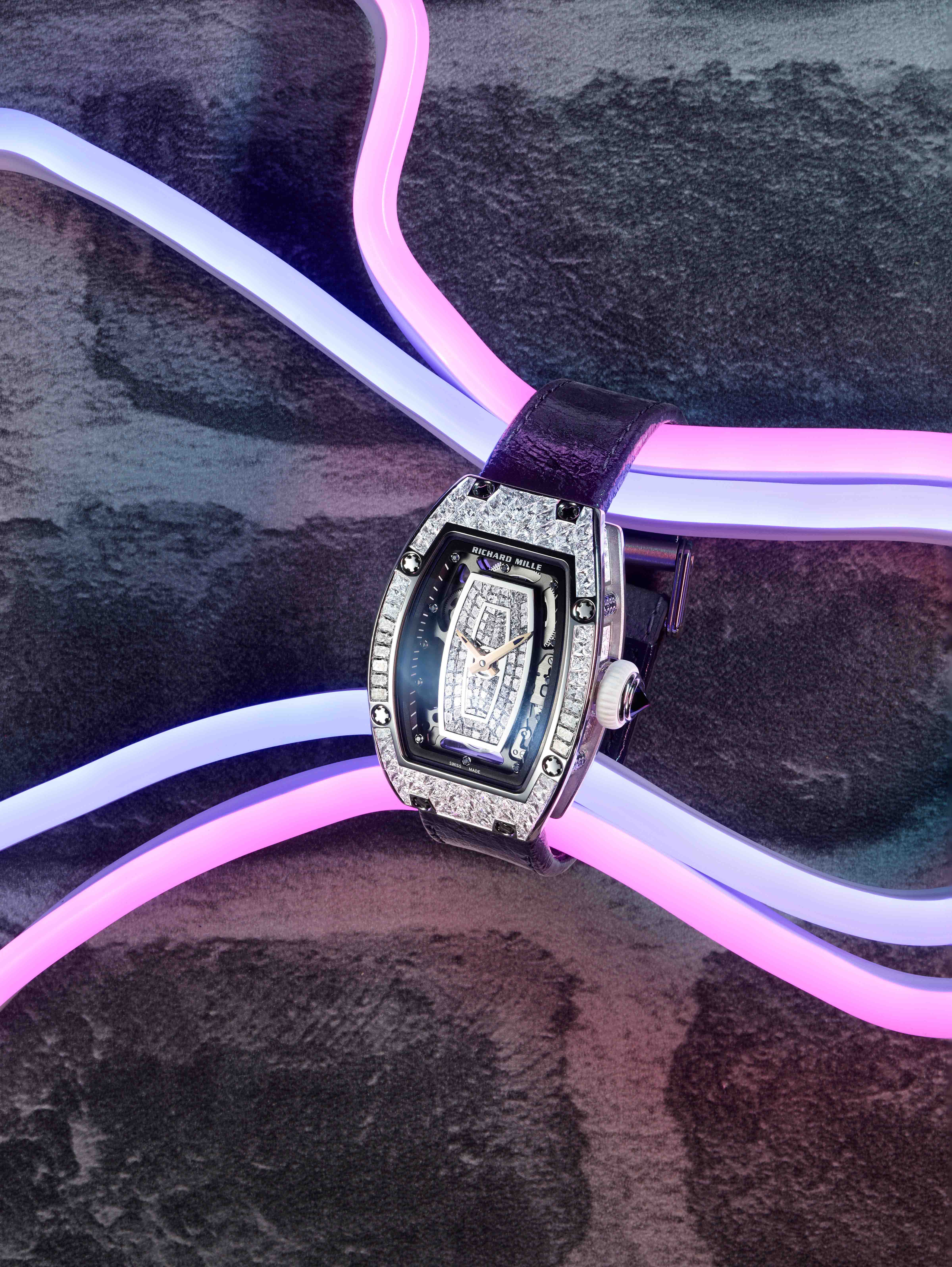 Elegant watch displayed with colorful neon led lights captured by KMA Still Life Photographer Daniel Schweizer for French