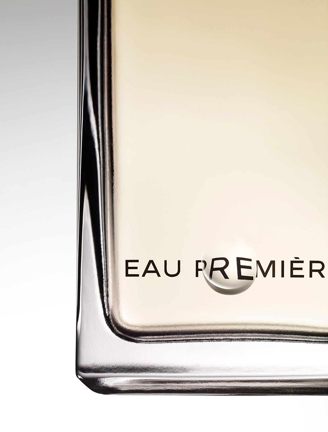 KMA photographer Isabelle Bonjean shoots gold perfume bottle with white background for Faux Q Magazine