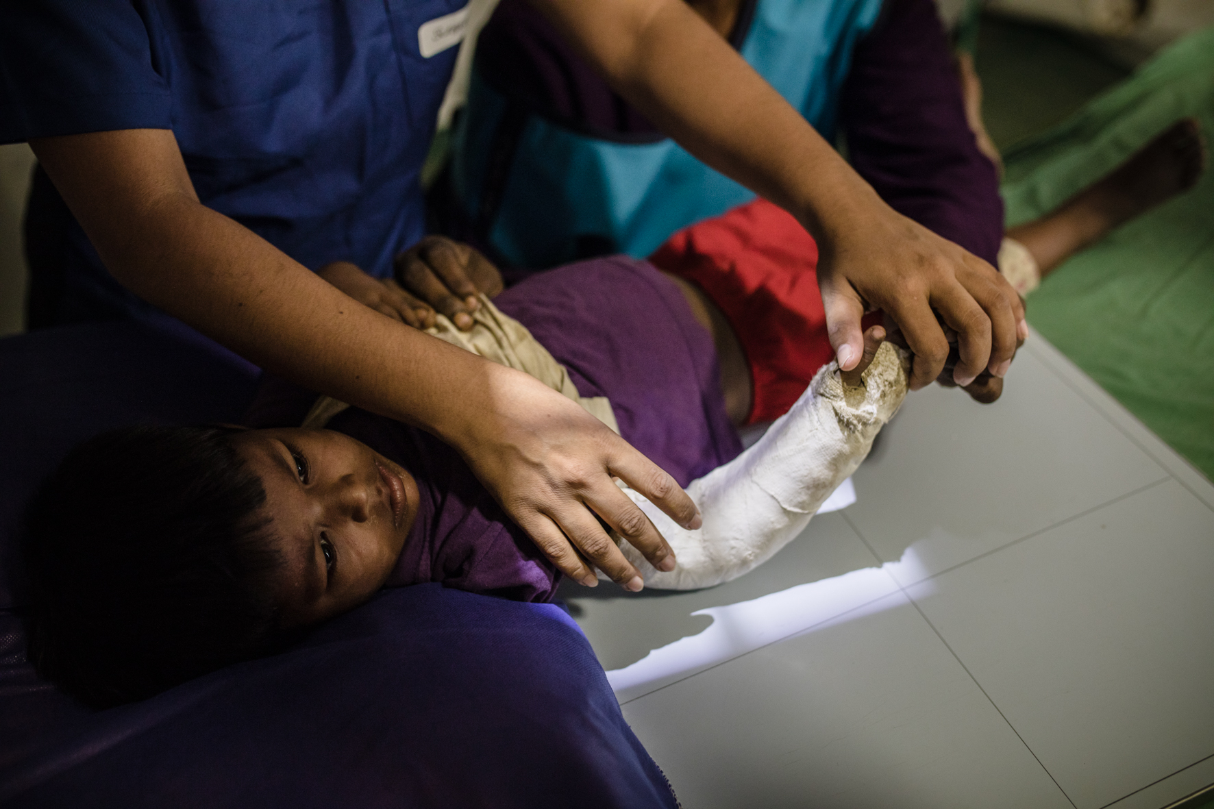 A young boy called Noor being prepared for an x-ray of his injured hand.