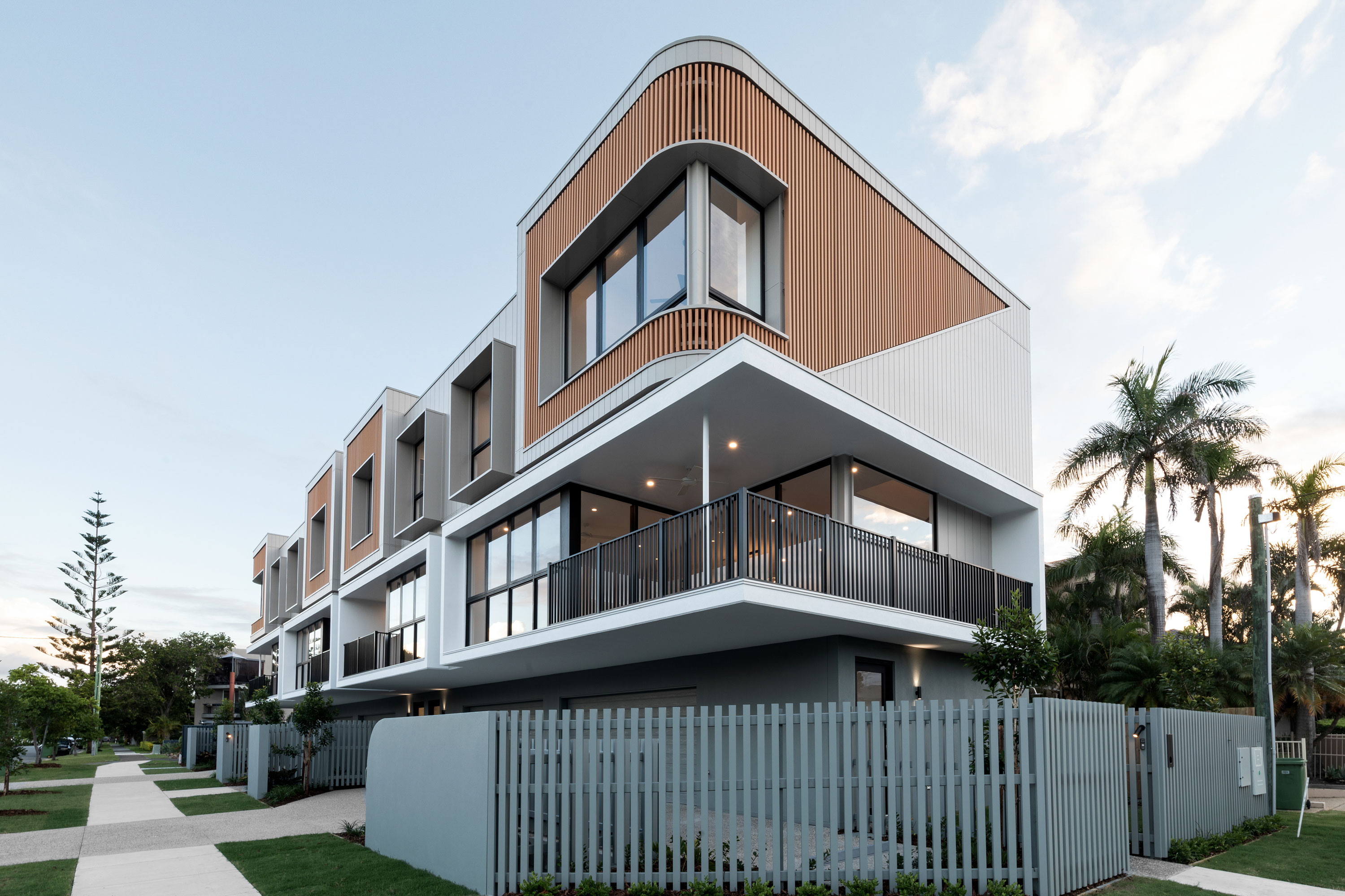 A modern development provides four terraced apartments with a contemporary and textured façade.