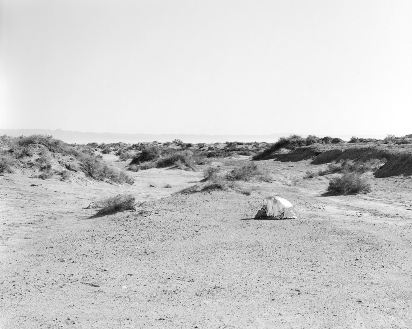 Child in emergency blanket in proximity of the test site. Silver Gelatin Fiber Print 2016