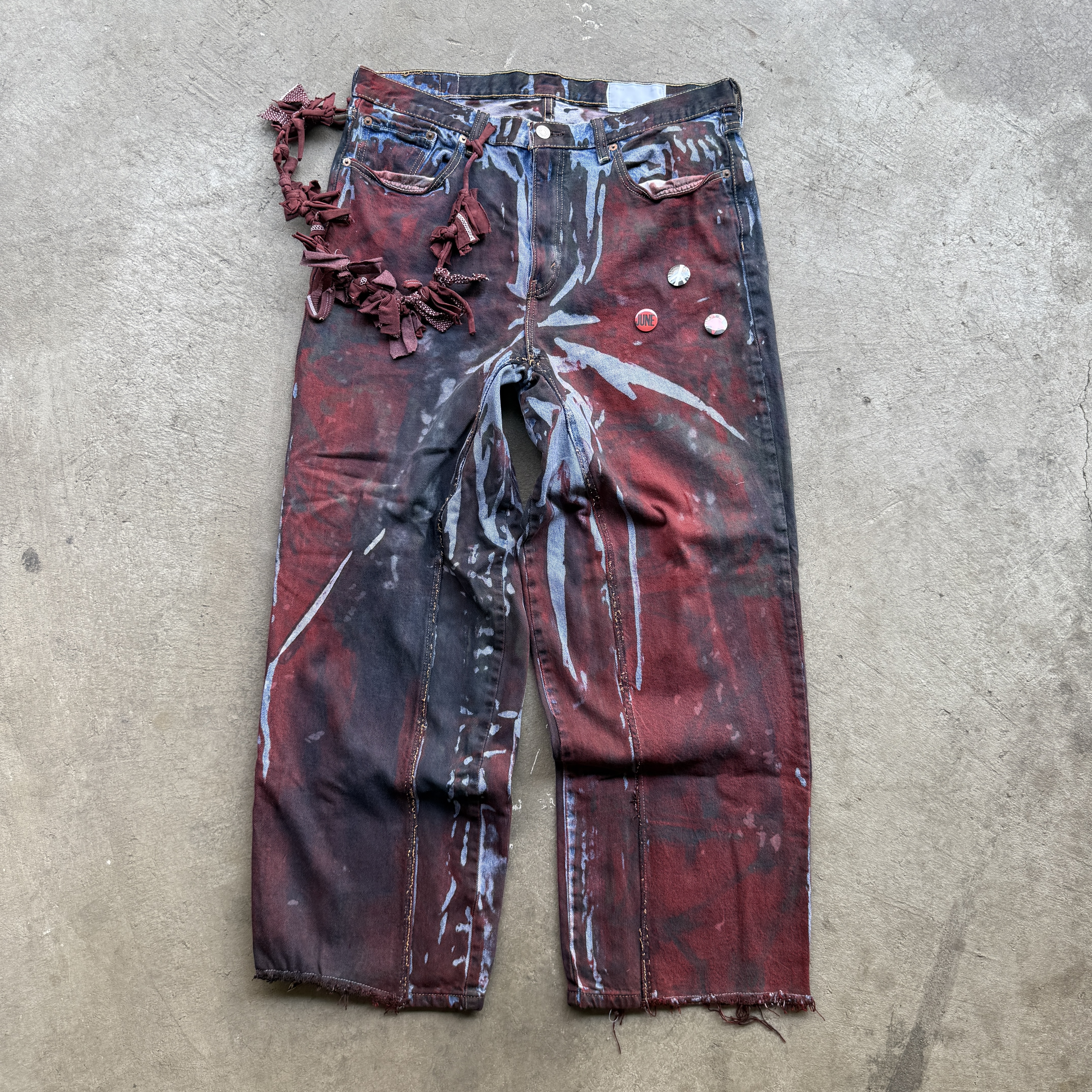 Reclaimed vintage surplus denim allover printed with copper, aluminum, iron & textile dye. Tailored to give a straight/wide fit. Fitted with dyed scrap chain, leather patches, and custom buttons
