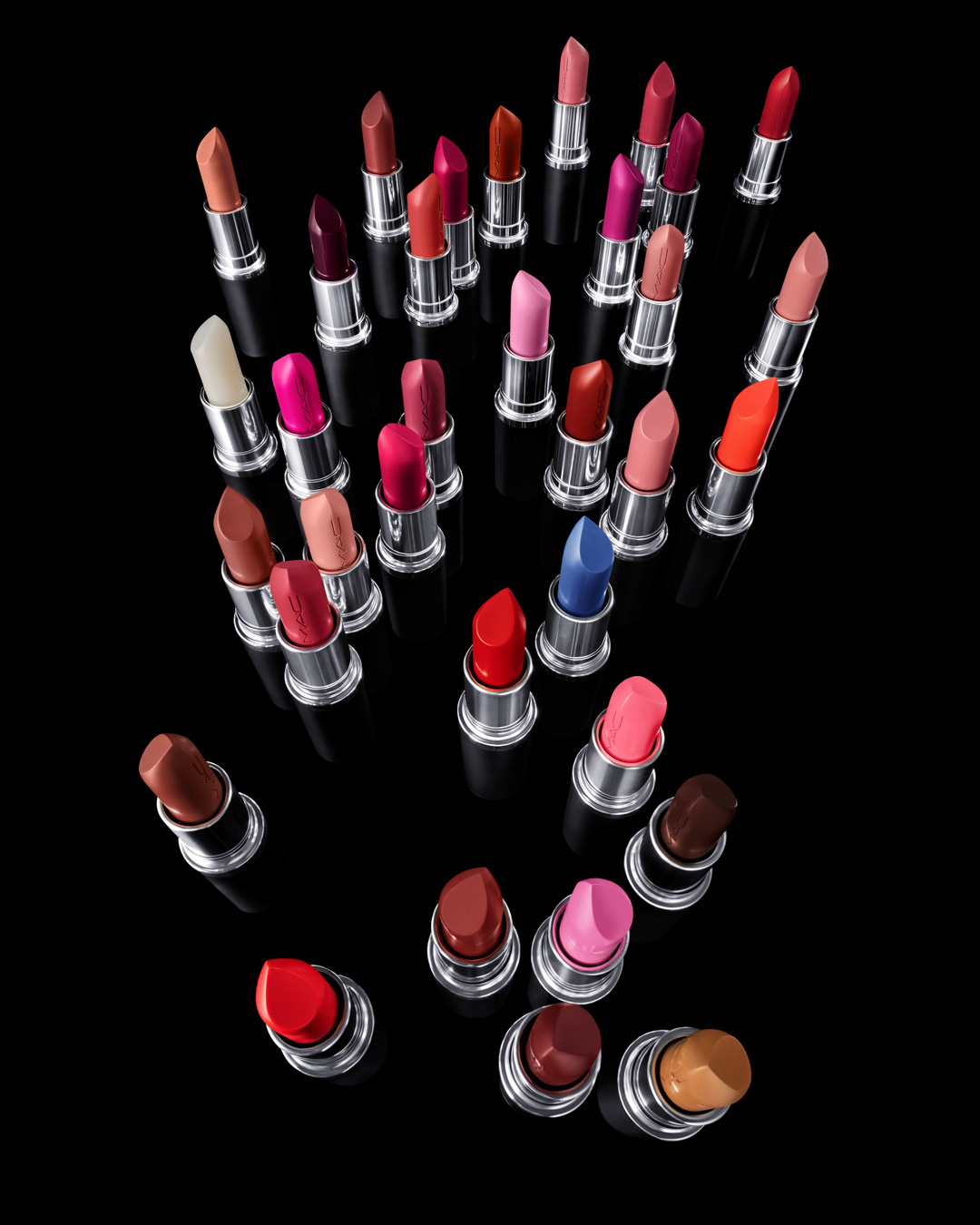 KMA stylist Rachel Haas designs set for photo of many shades of concealer sticks on black background for Hourglass