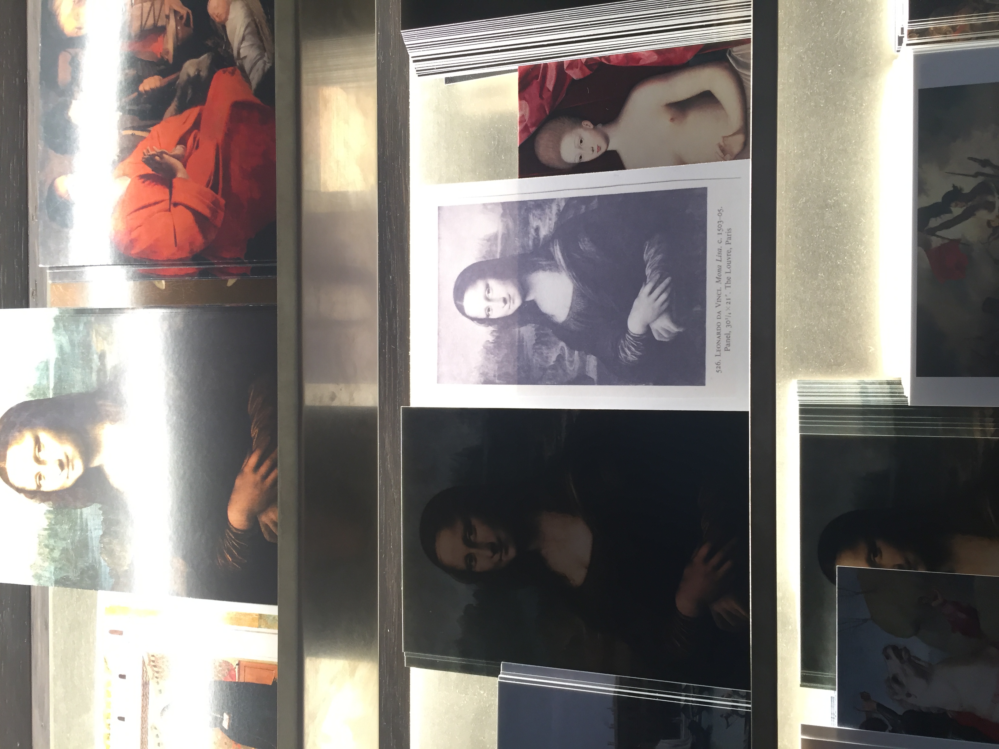 Straight up used the black and white reproduction of the Mona Lisa from an art history textbook from the 1970s for this. Also placed a few of these cards with the Mona Lisa postcards in the Louvre's gift shop. The presence of the original is not a prerequisite. 