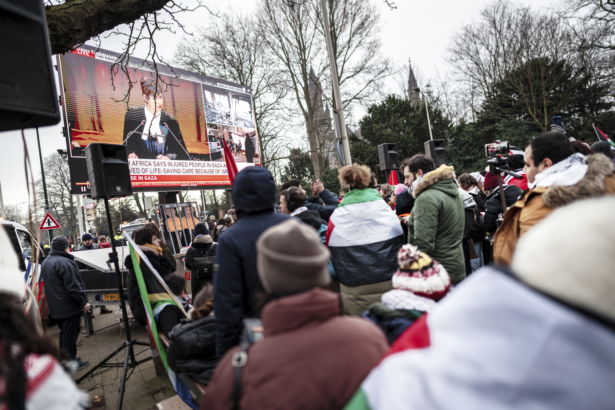 Pro-Palestinian demonstrators gather to watch a live stream of the court case at the Peace Palace in The Hague.