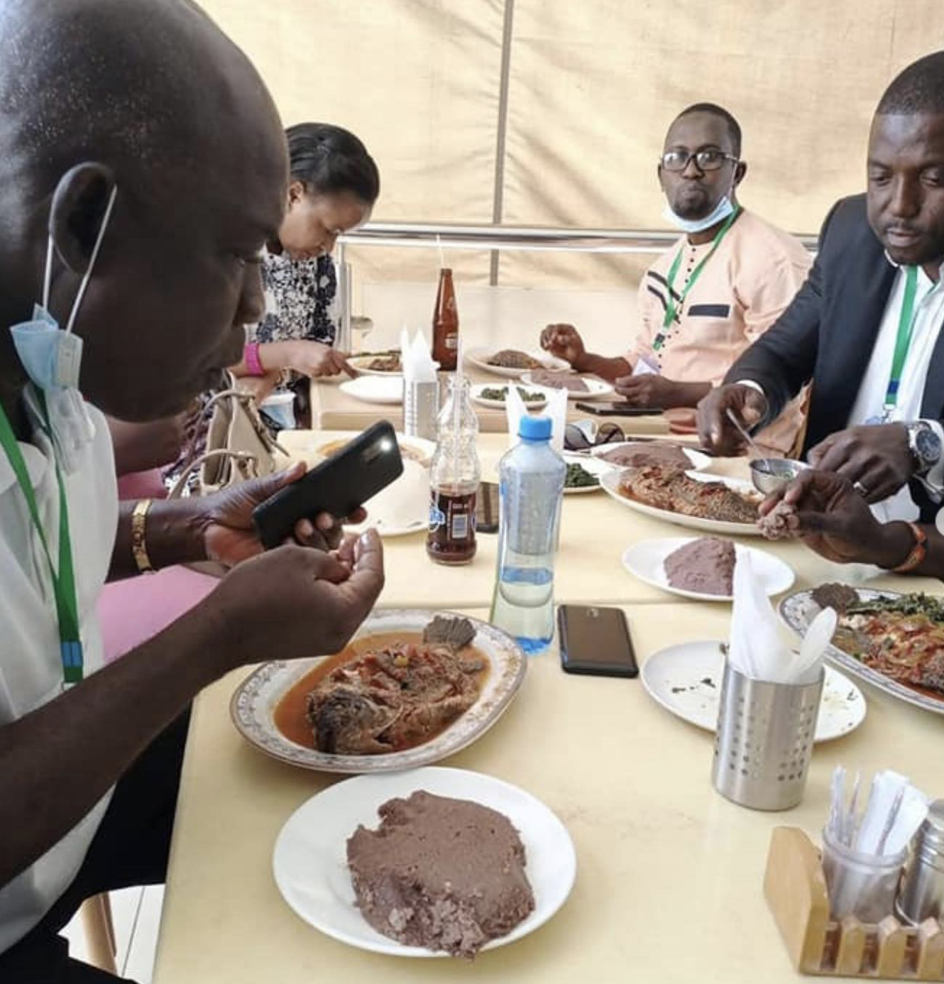 Musee Guinee study group members enjoy a meal with their hosts in Nairobi
