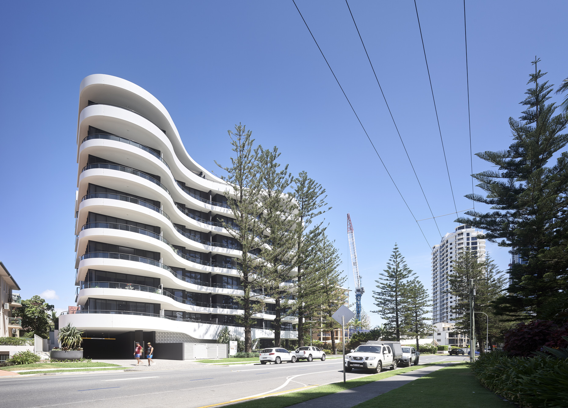 Sweeping white curved balcony edges and a controlled material palette define this 8 level apartment building.