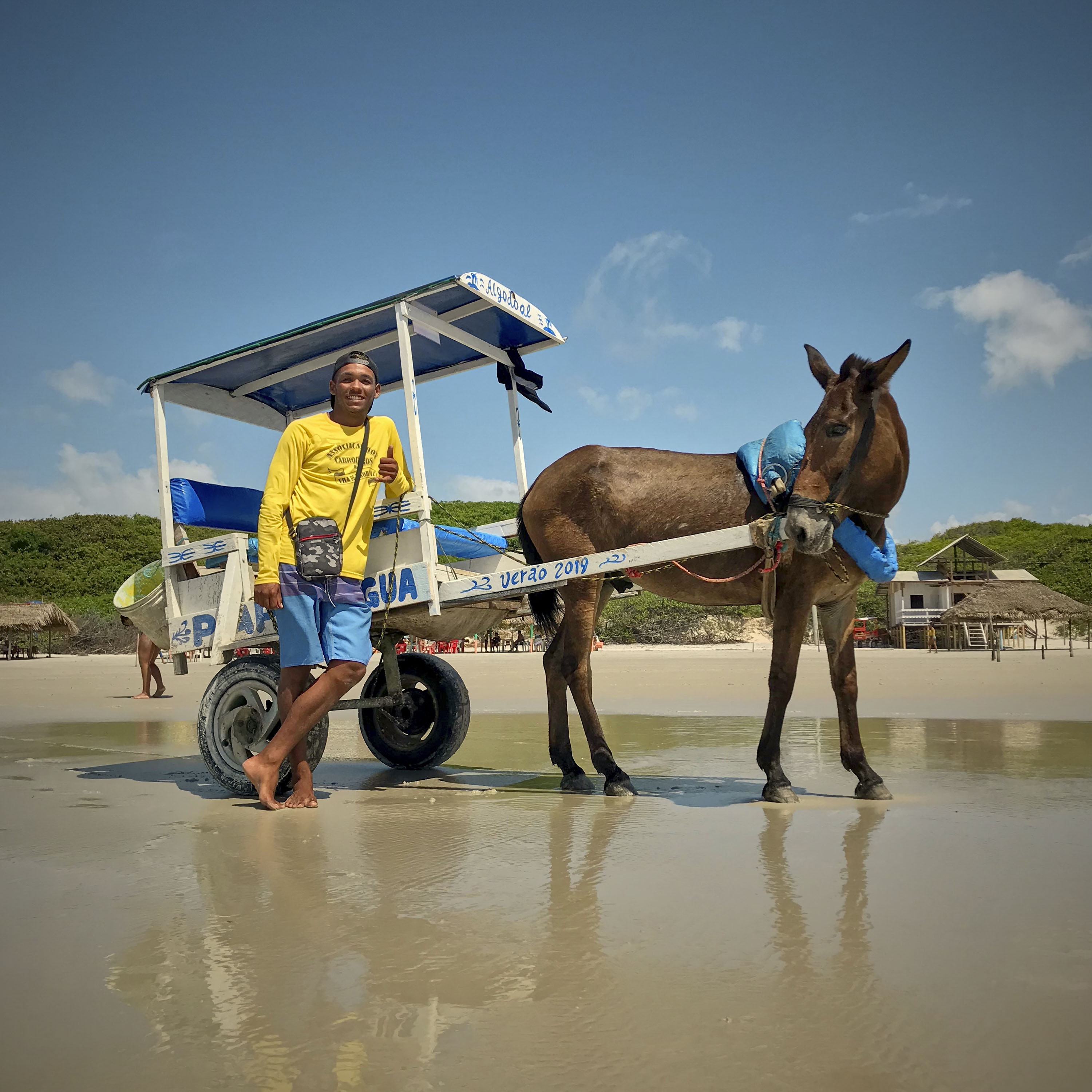 Otavio poses for a portrait next to his horse Papa Legua.