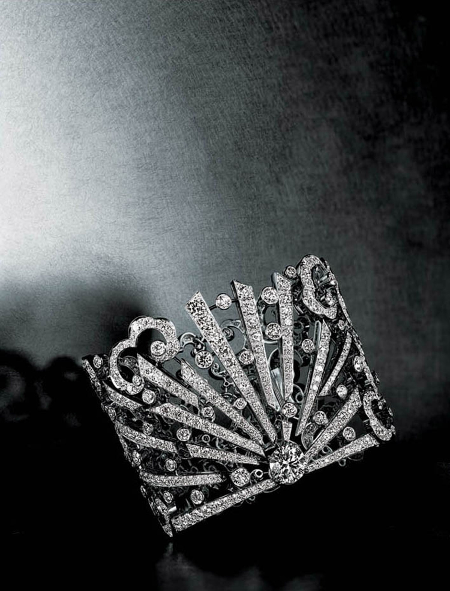 KMA stylist Sara Wacksman designs set for a photo of an elaborate diamond ring resting on a black surface