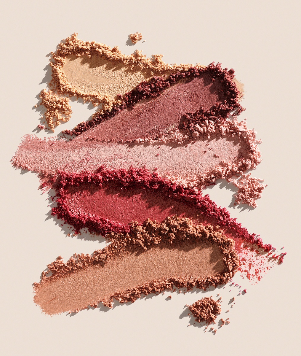 KMA photographer Mattias Nyhlin photographs several shades of blush scattered on tan background for Kicks 