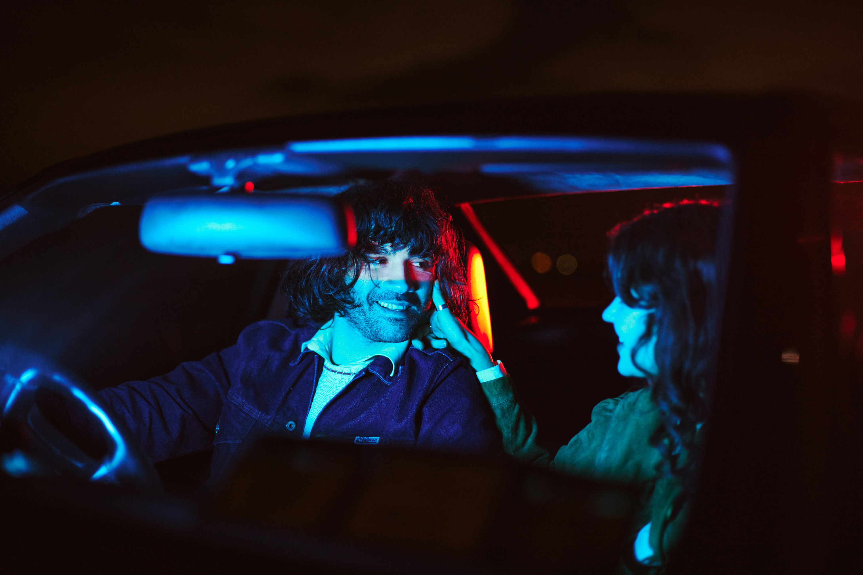 A story of young love in the suburbs told through photography, featuring stylish models in vintage clothing, photographed at sunset in Dublin, Ireland by fashion and lifestyle photographer Alex Sheridan. Suburban Love photo series. Featuring a vintage 1993 Mercedes Benz SL class and cinematic lighting and red light. Euphoria inspired photoshoot.