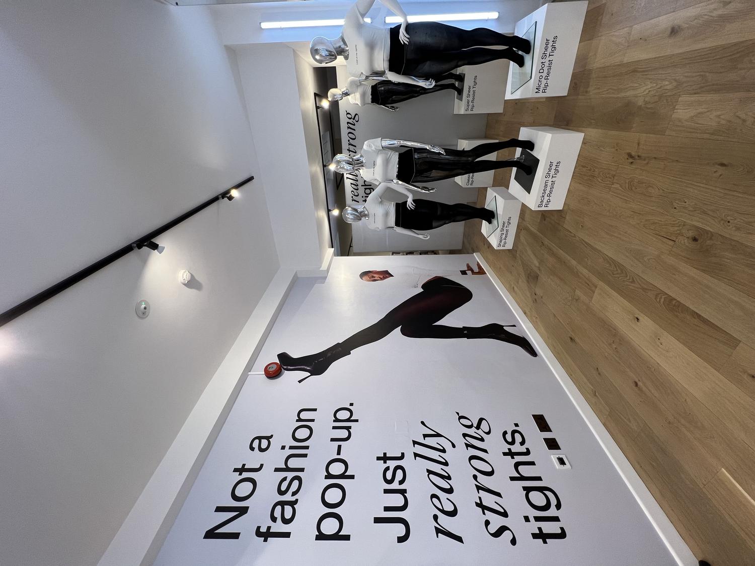 Mannequins wearing Sheertex tights inside the pop-up store with slogan 'Not a fashion pop-up. Just really strong tights.'