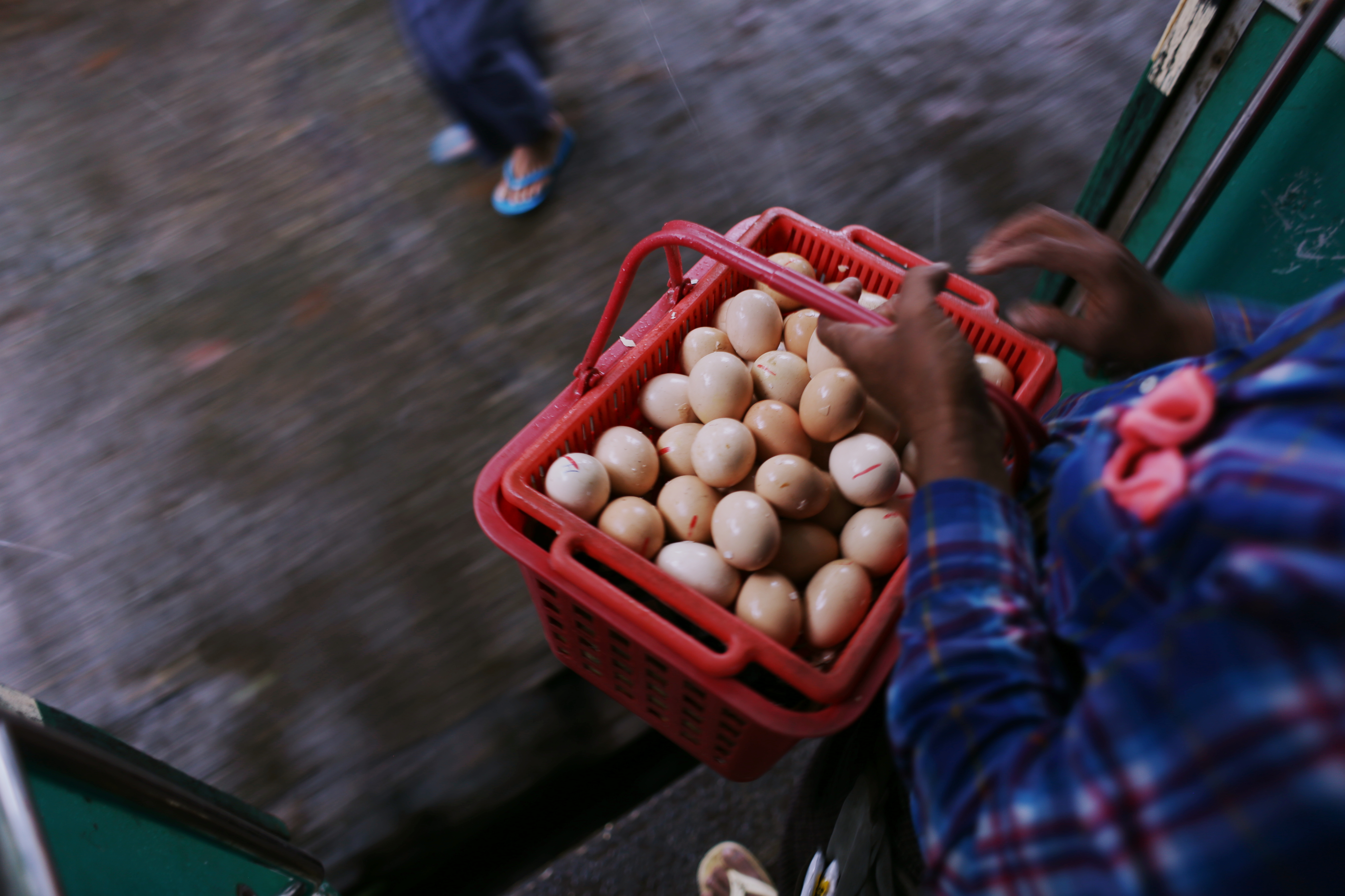 The carriages are filled with vendors peddling their wares: bananas, newspapers, tobacco, smoked fish, chicken and quail eggs, lurid melting icy poles in clouded plastic bags. As the train approaches each station, more traders run along the platform. Before the train has stopped they mount the steps with dexterity and begin singing and shouting at anyone who will listen.