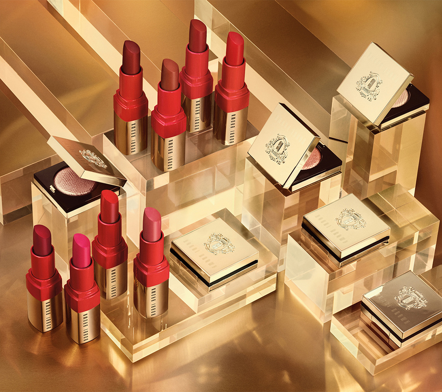 KMA stylist Sara Wacksman designs set for photo of Bobbi Brown lipsticks and blushes with shiny gold blocks in the background