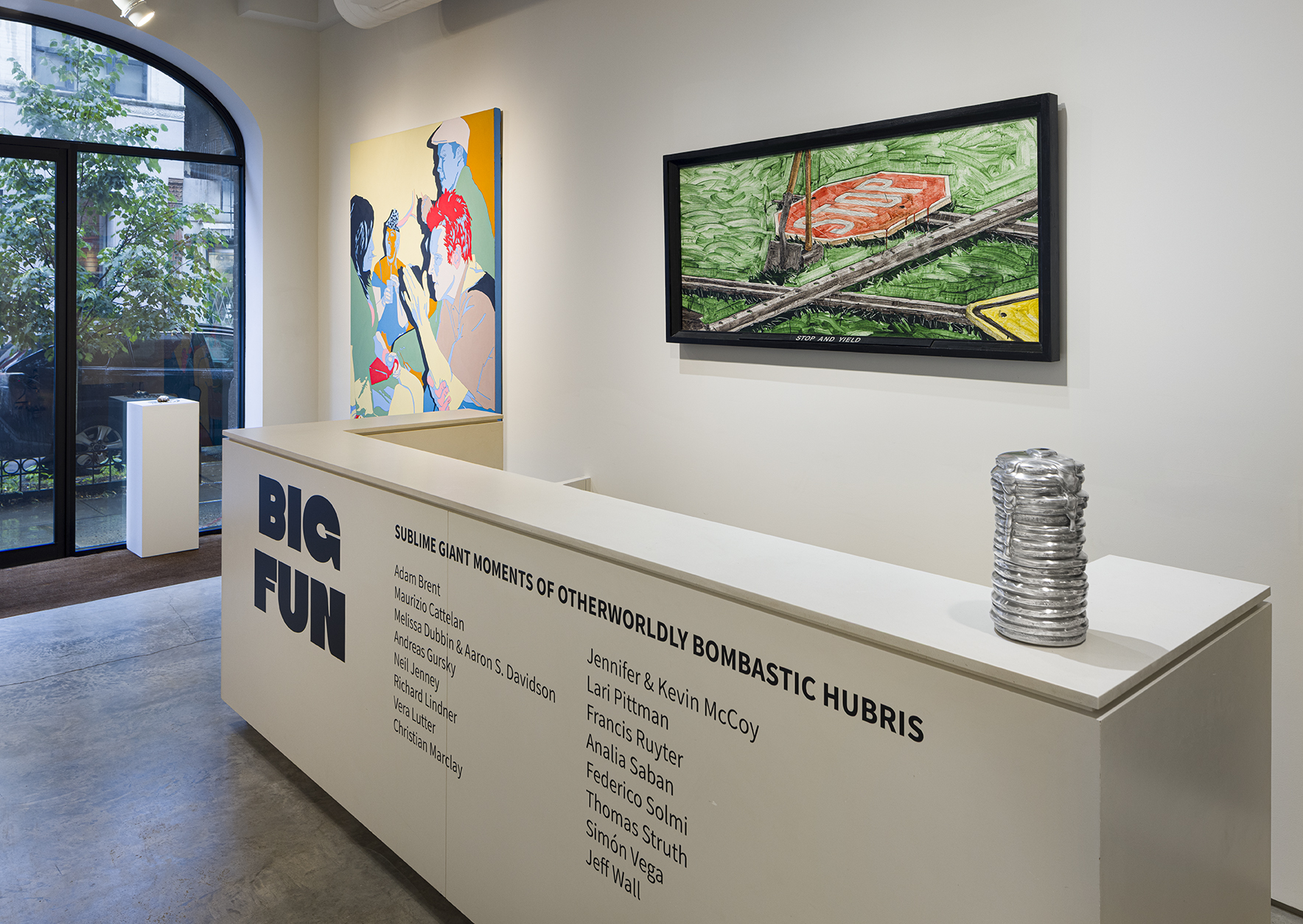 From left to right: Jennifer and Kevin McCoy, Spill Series: Cat, 2019. Cast and poured tin alloy, 1 1/2 x 10 1/2 x 7 1/2 inches; Francis Ruyter, Distilled Spirits, 2002. Acrylic on canvas, 96 x 72 inches; Neil Jenney, Stop and Yield, 1970. Acrylic and graphite on canvas in artist’s painted frame, 33 1/4 x 70 3/4 inches; Adam Brent, Pancakes, 2021–2022. Carved aluminum, 12 x 6 x 6 inches. Photo by Etienne Frossard.