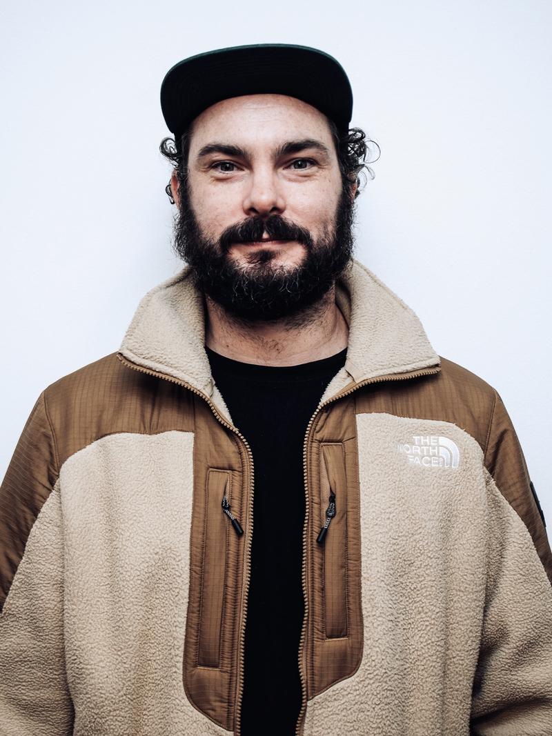 Dave McDonogh, Senior Producer at UP! Productions, wearing a tan and beige North Face fleece and cap.