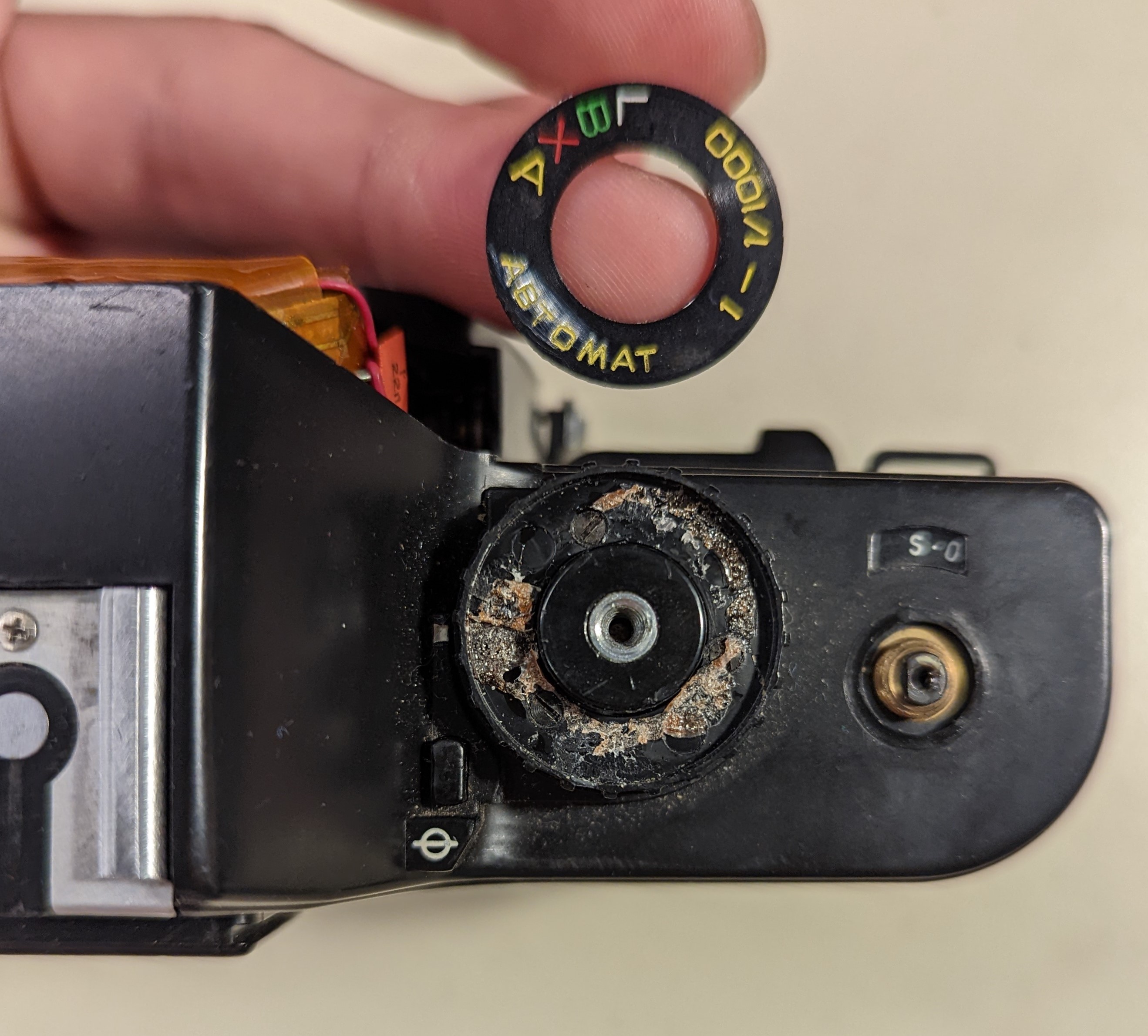 8. Pried the front piece off the shooting setting dial.