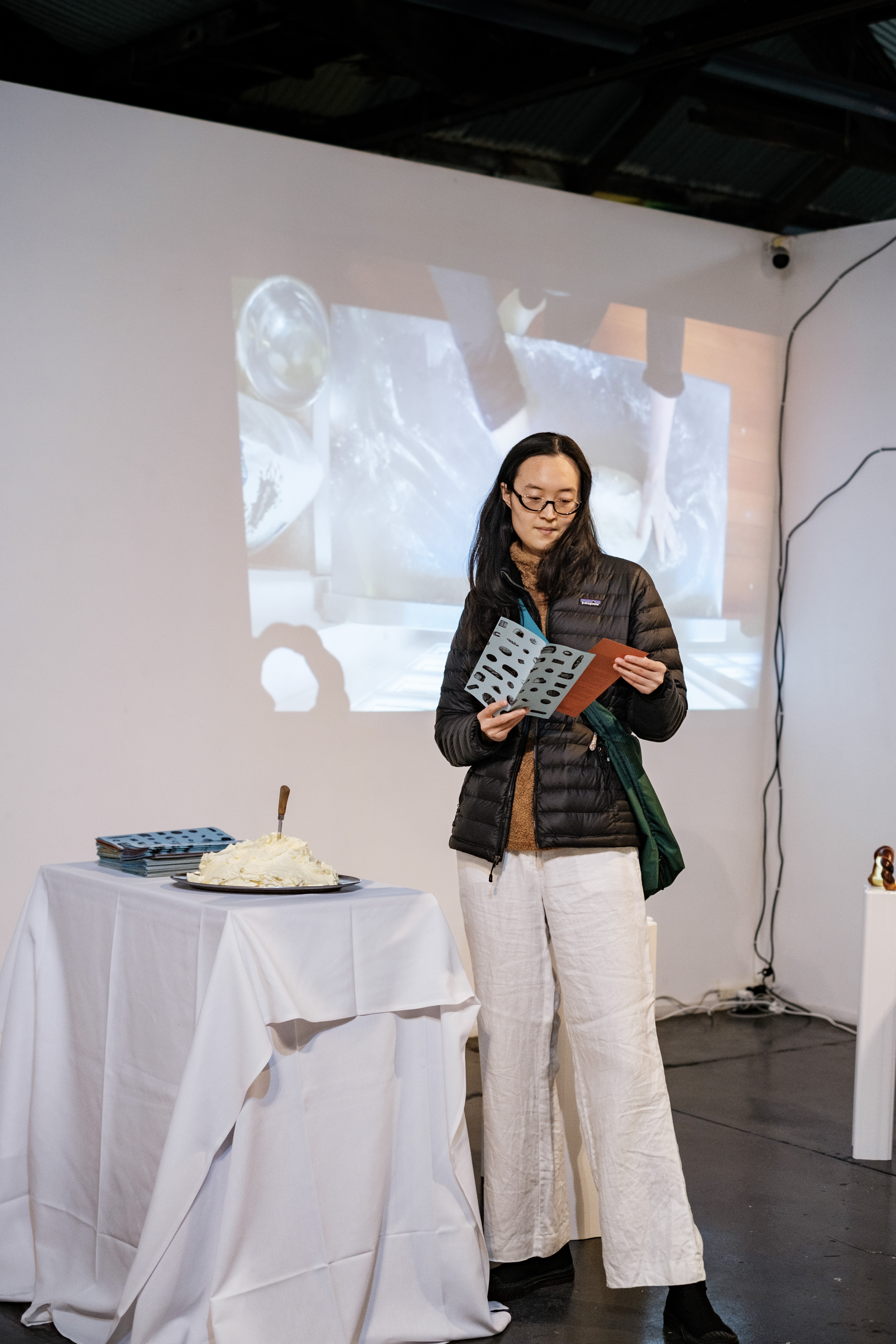 'Kneading' videowork is projected into the gallery space, alongside a pamphlet detailing the project. Accompanied by a mound of whipped butter. Photograph by Temitope Adesina.