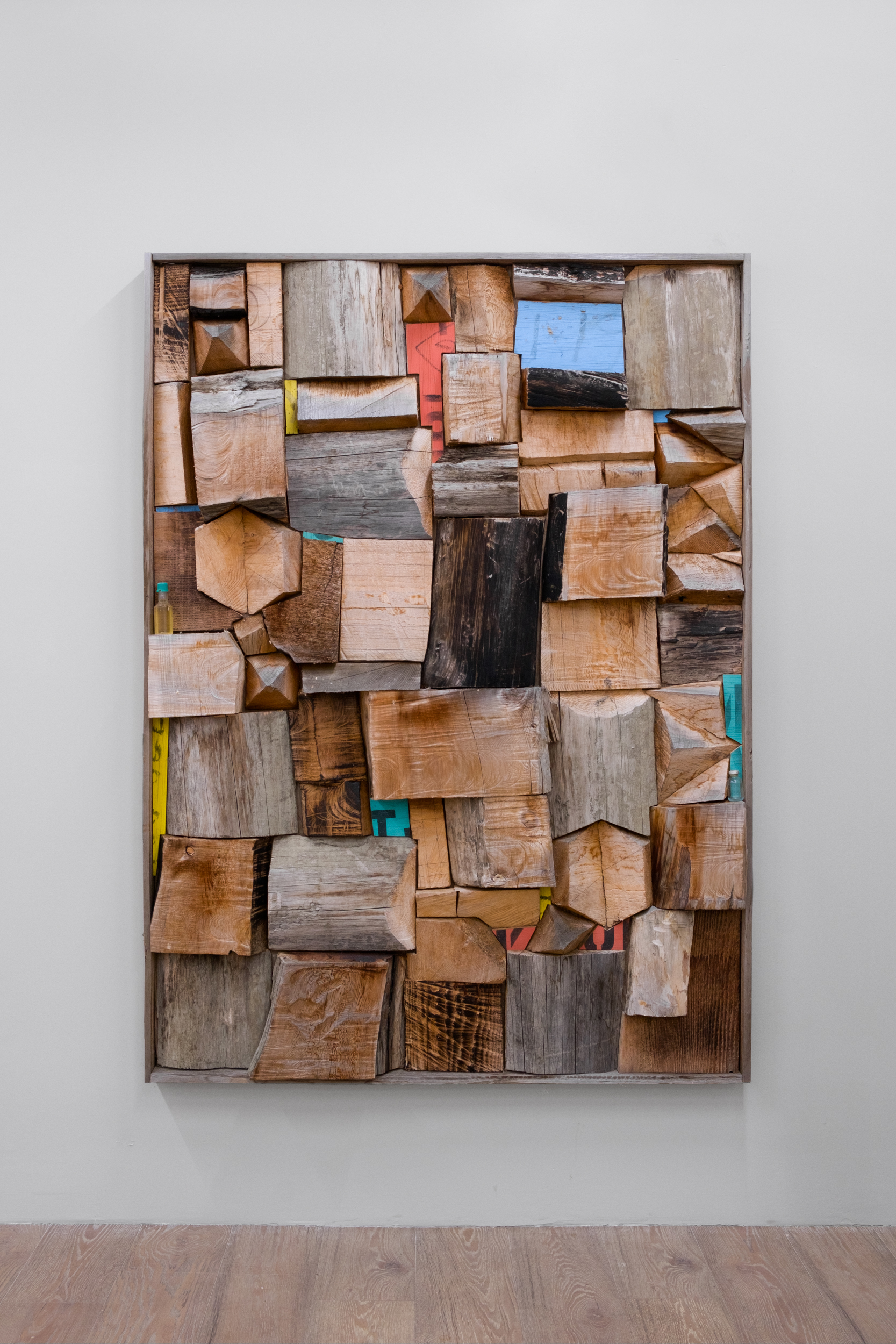 Plowland, 2021, 67 1/2” x 49 1/2” x 3 1/2”. Red cedar, boom boards, miniature liquor bottle, sterile glass vile.