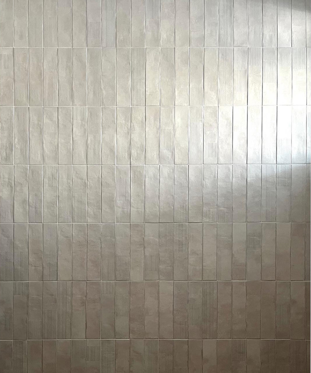Interior detail photo of the Brant Beach renovation, showcasing a modern vertical rectangular tile installation, possibly in a bathroom or as a feature wall.