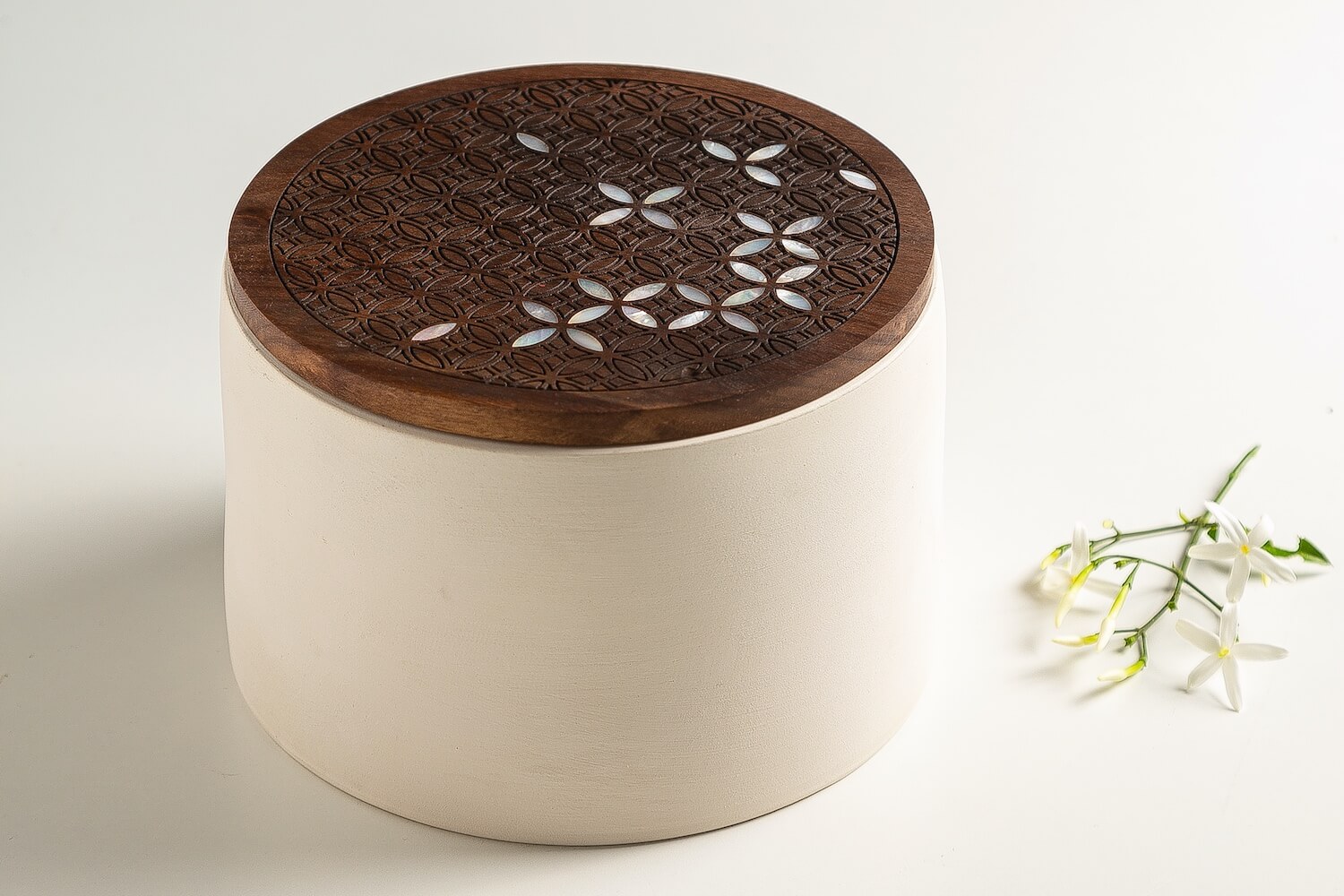 A ceramic box with wooden lid inlaid with a jasmin flower pattern