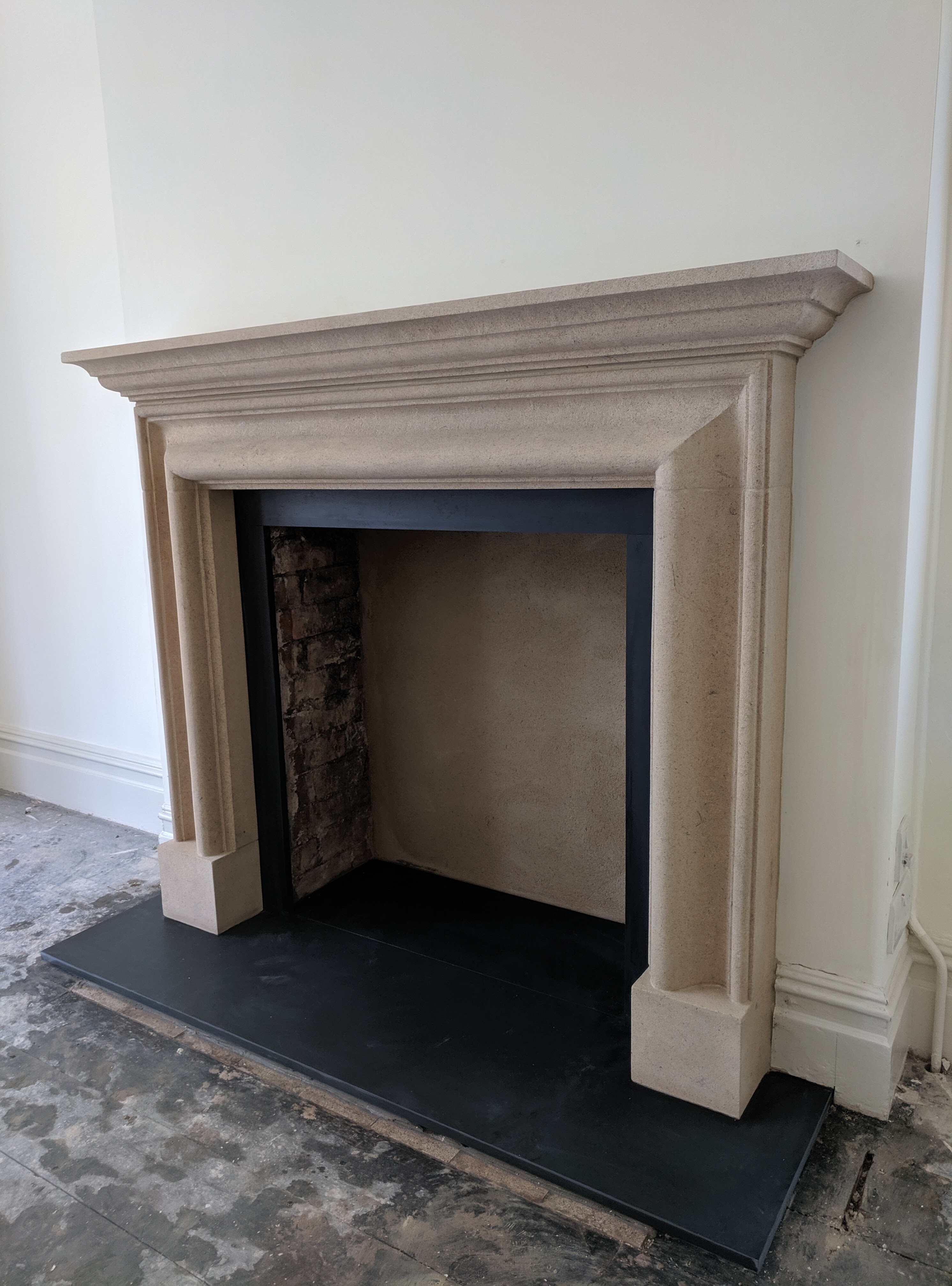 Bolection in Bath stone, with slate  hearth and slips