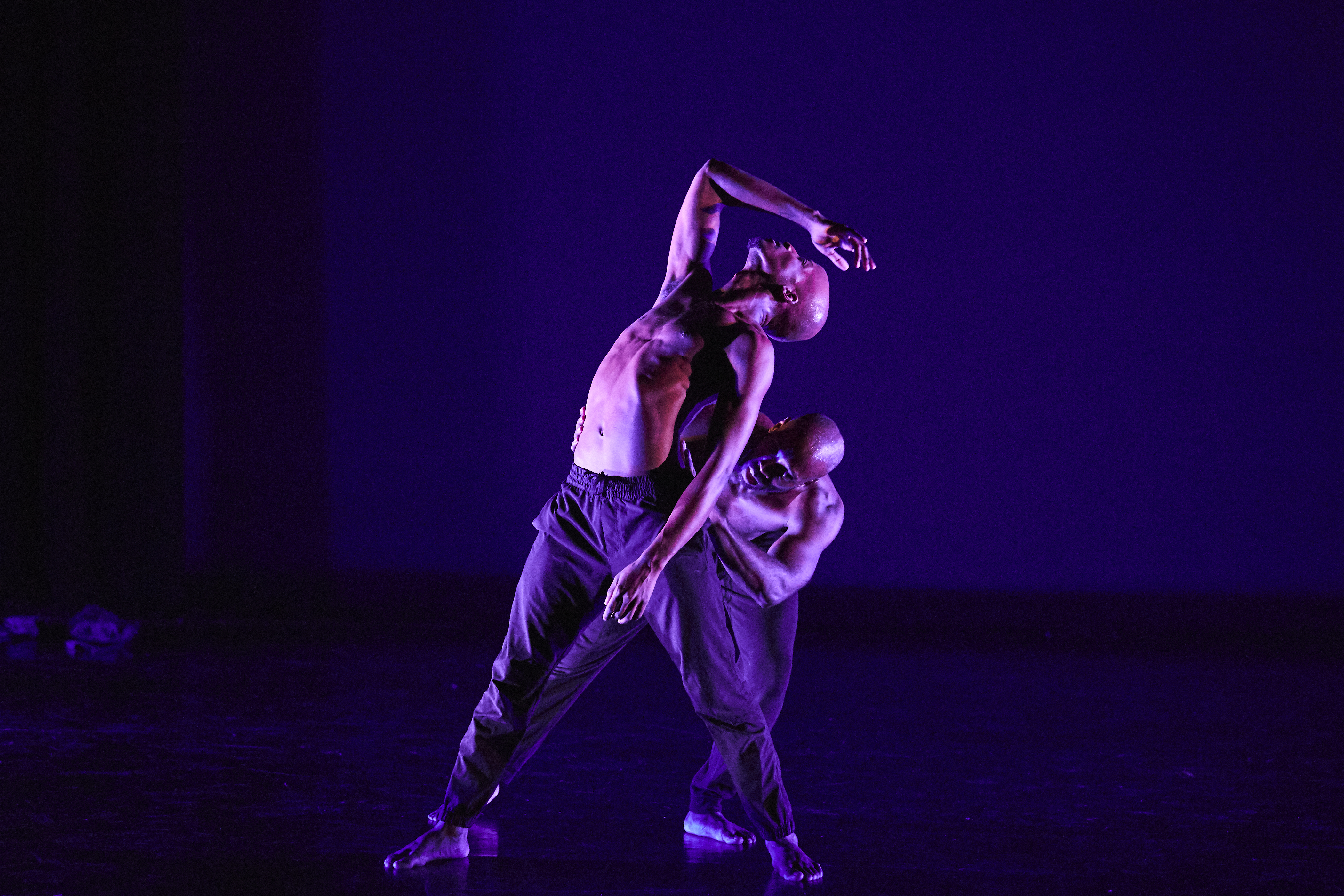 Image 4 of 6: Two young black men in a dramatic dance pose