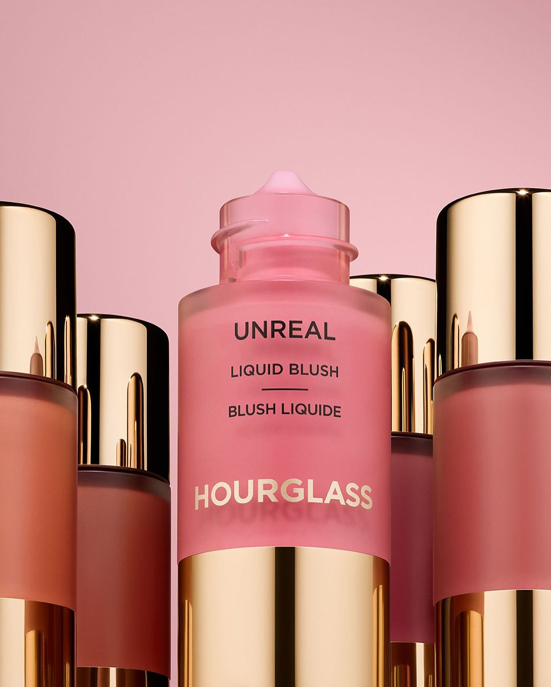 KMA stylist Rachel Haas designs set for photo of many shades of concealer sticks on black background for Hourglass 