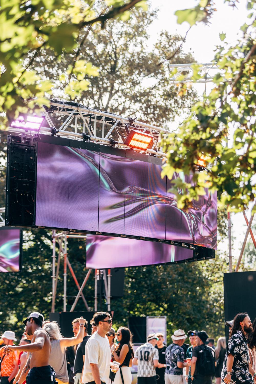 Crowd with vibrant lights and visuals at AVA IMMERSE stage