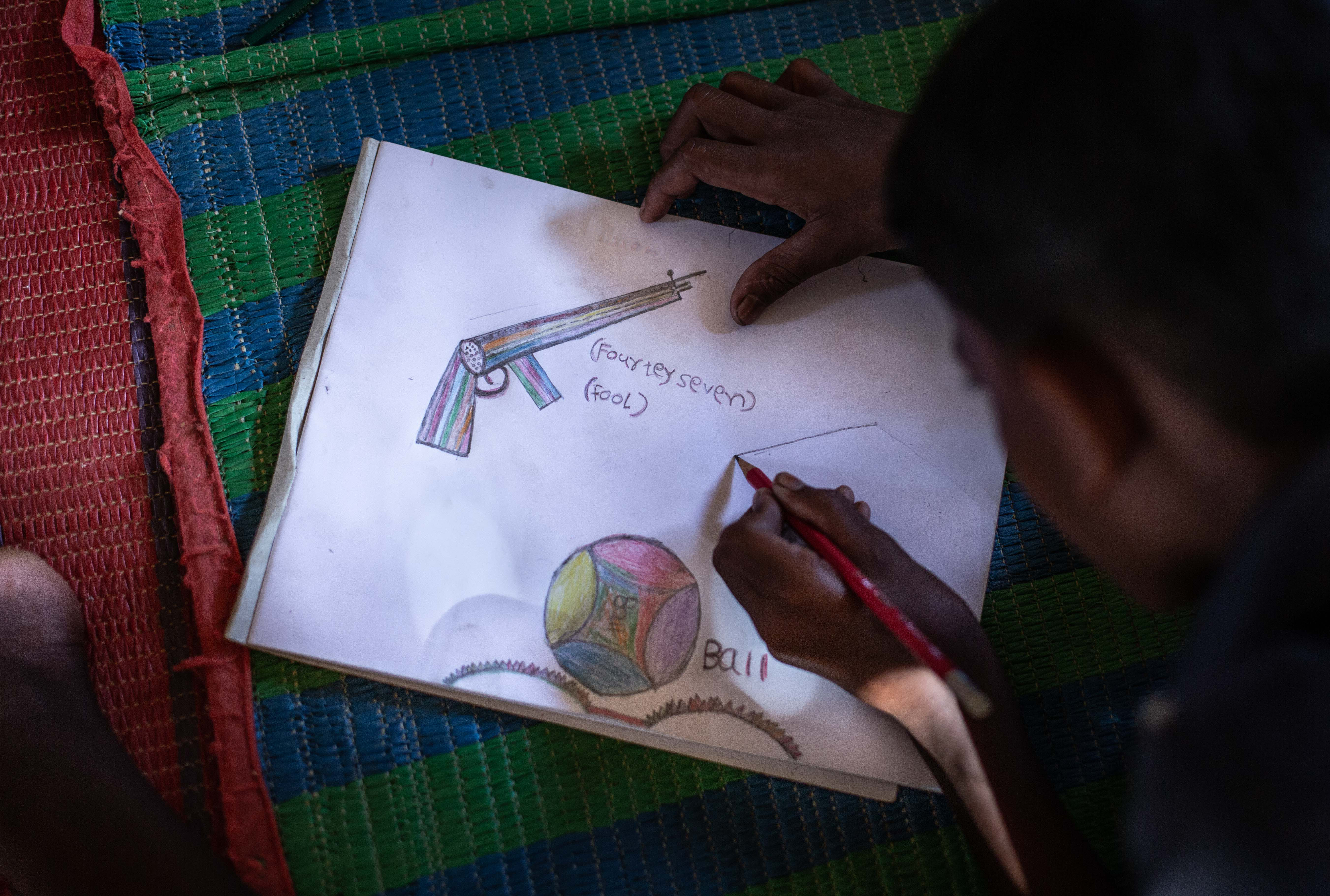 A young Rohingya boy (name redacted and blurred for safety) draws an AK-47 as part of his envisioned future. “When I grow up, I want to take this gun to Myanmar and fight.” Balukhali refugee camp, on August 10, 2018.
