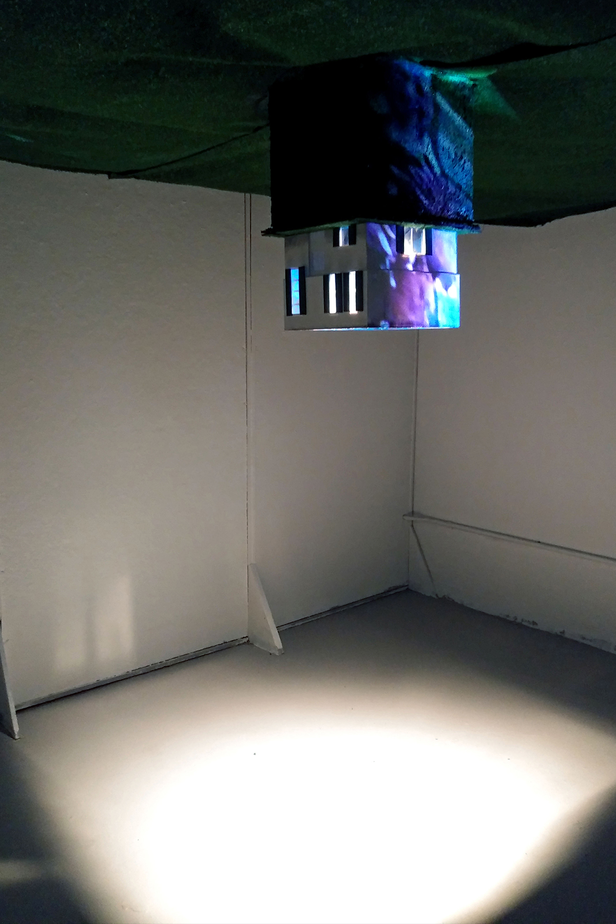 Abduction, 2019, foam board, polystyrene sheets, wood, paint, dirt, AstroTurf carpeting, video projection, dimensions variable.