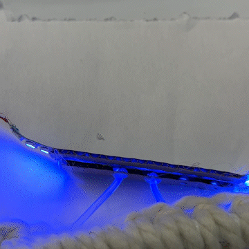 I added a small strip of cardboard on either side to hold it all in place, and secured 2 of the cables with a large amount of hot glue, and it worked!