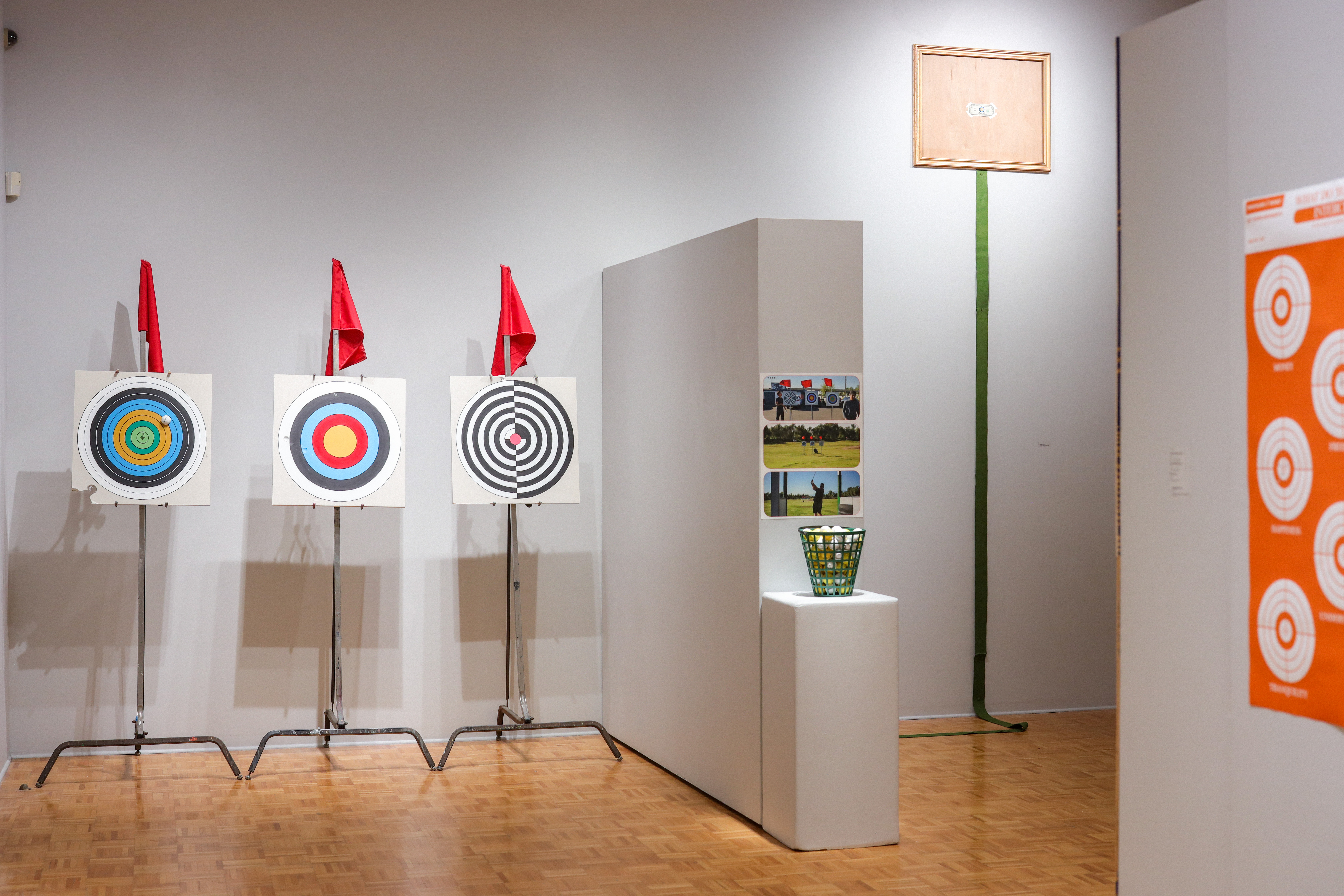 Painted dry wall targets installed on a golf range to have people interact with by hitting balls at the paintings.