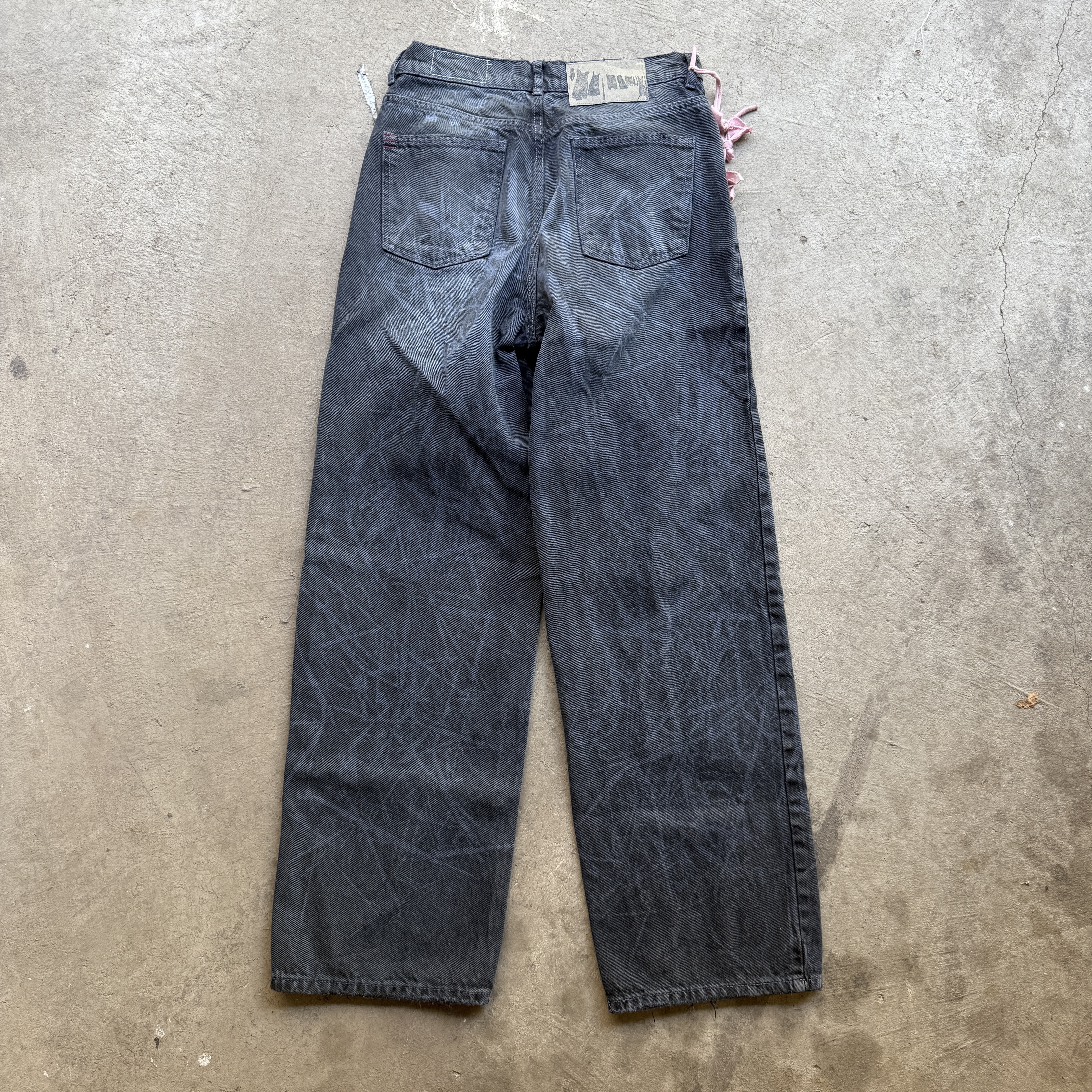 Reclaimed vintage surplus denim screen printed with grass pigment & textile dye. Tailored to give straight/wide fit. Fitted with dyed scrap chain, leather back patch, and custom buttons.
