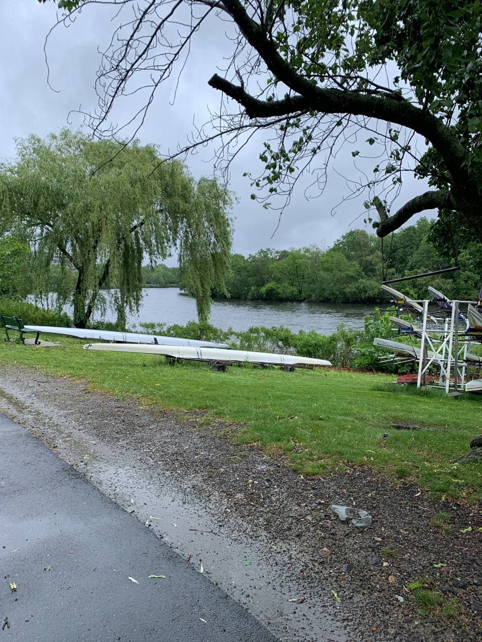 The Charles River; boats lie on the grassy shore.